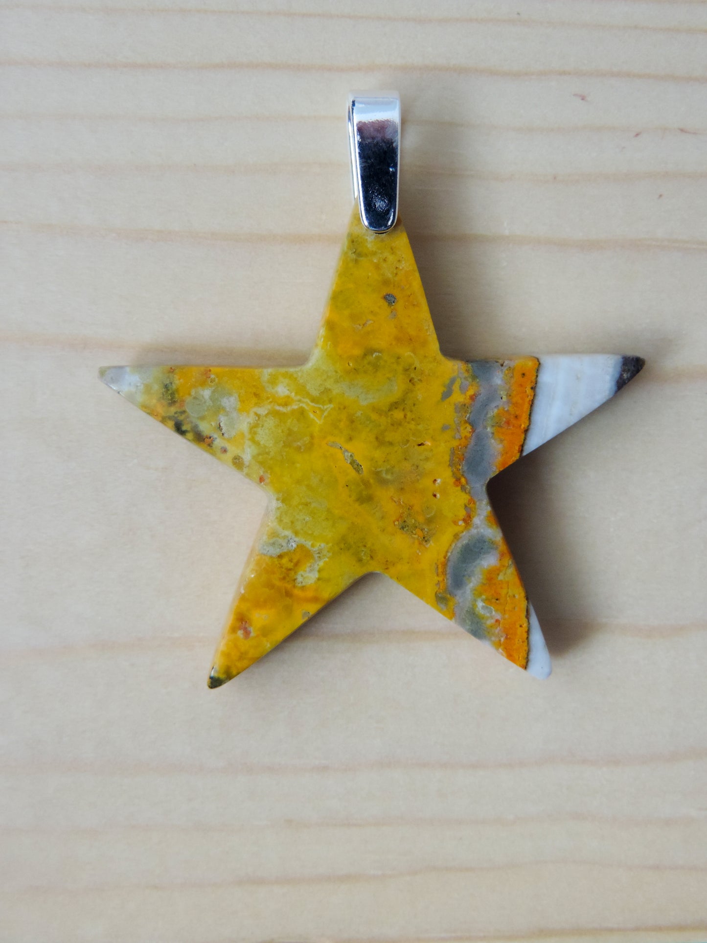 Bumblebee Jasper pendant is named for its yellow, white, orange and black colored banding which resembles a common bumblebee. This mineral was discovered in the Papandayan Volcano, West Java Province, Indonesia. The pendant bail is authentic 925 sterling silver. Great gift idea!