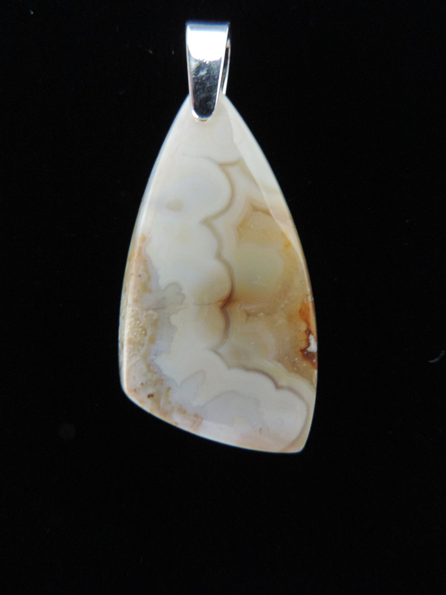 Brown Lace Agate pendant from West Sumatra. Indonesian Agates pendants exhibit a wide variety of colors and amazing complexity. No two agates are exactly alike, each one being a unique and beautiful creation! The pendant bail is authentic 925 sterling silver. Our hand crafted jewelry is photographed next to a ruler for size. This stone is a natural color, no dyes or heat treatment have been used.