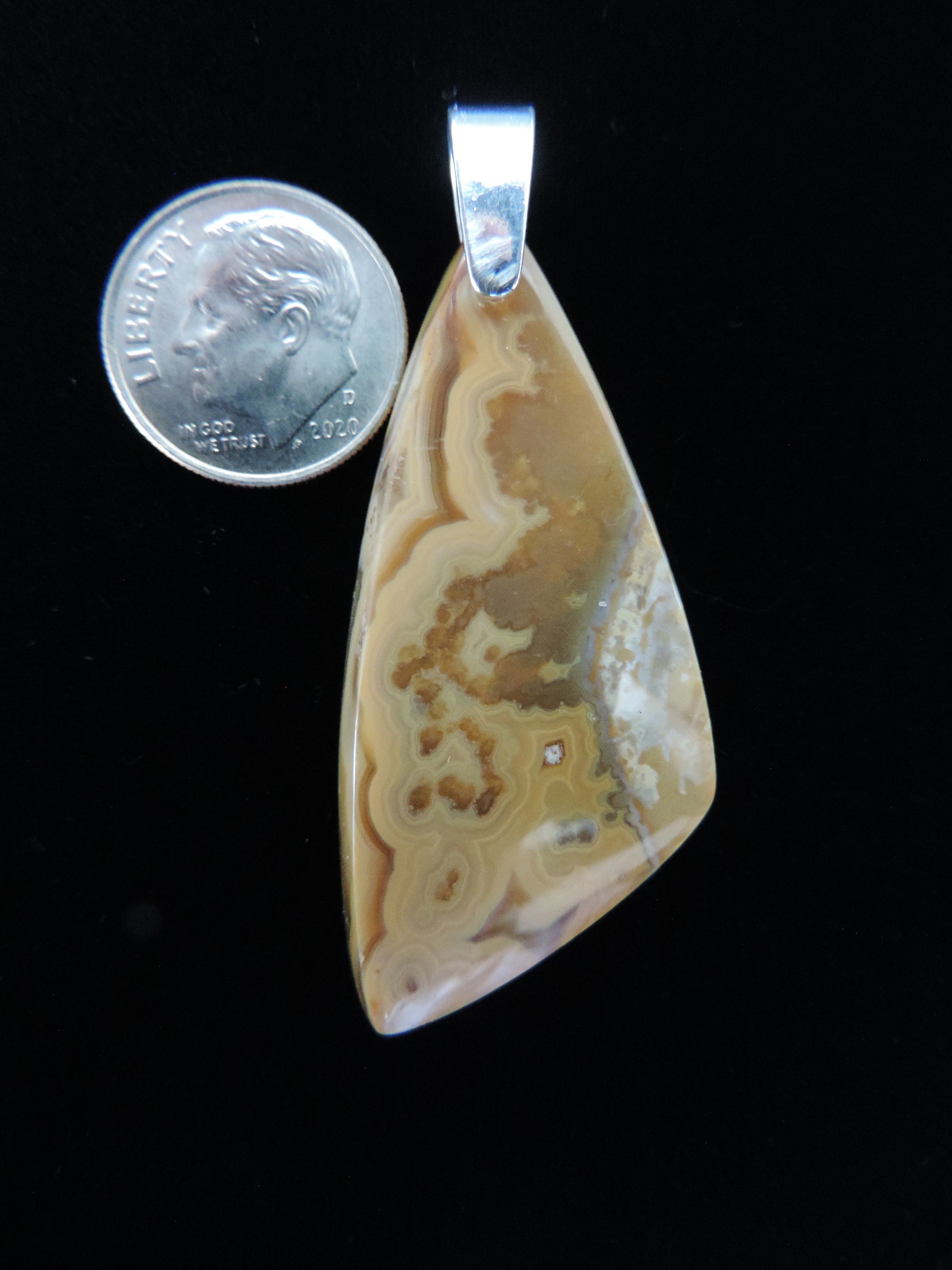 Our hand crafted jewelry pendant is photographed next to a ruler for size.  This stone is a natural color, no dyes or heat treatment have been used.