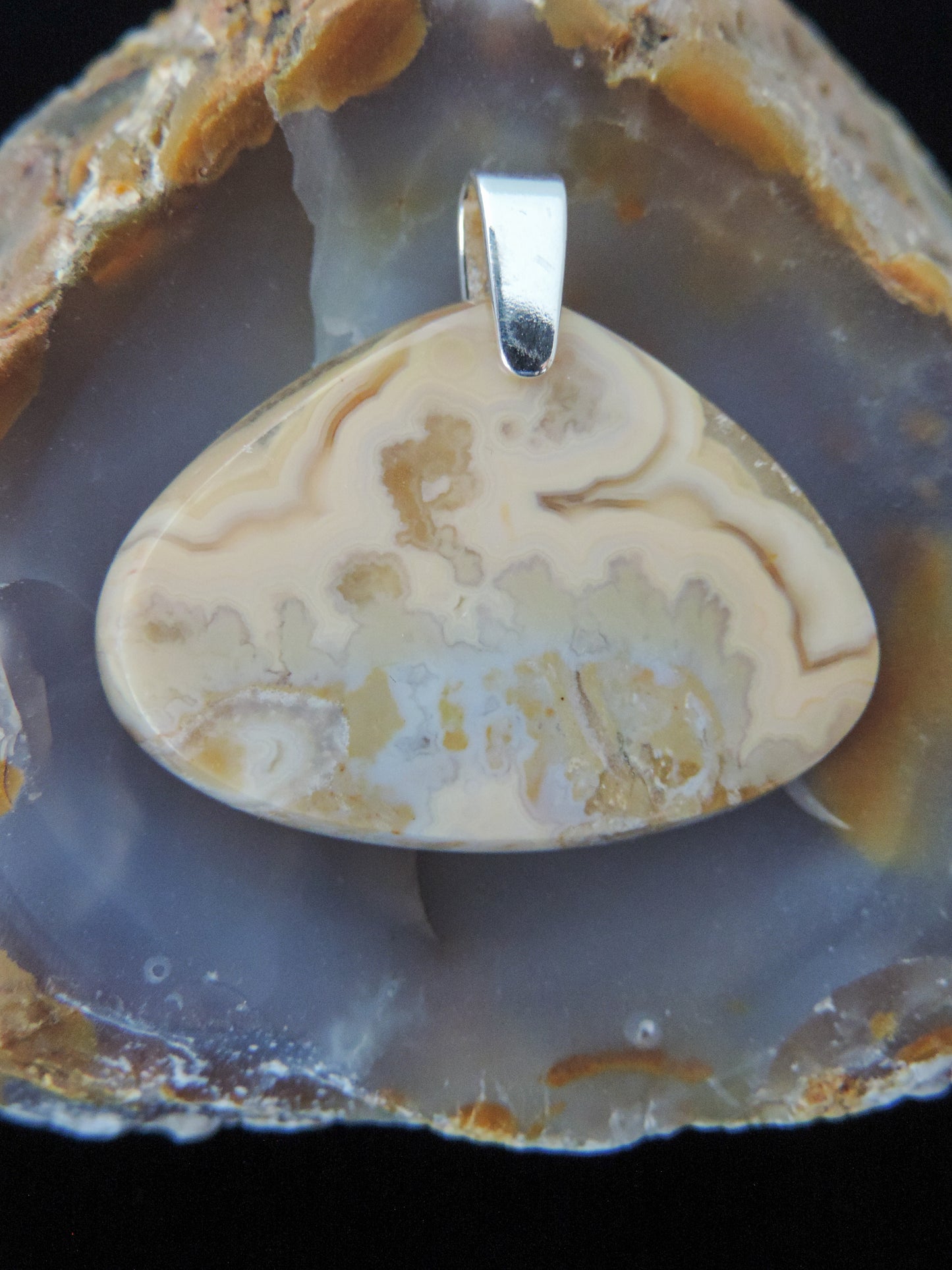 Find your perfect Indonesian Agate pendant on our store! The pendant bail is authentic 925 sterling silver. Our hand crafted Our hand crafted jewelry is photographed next to a ruler for size. This stone is a natural color, no dyes or heat treatment have been used.