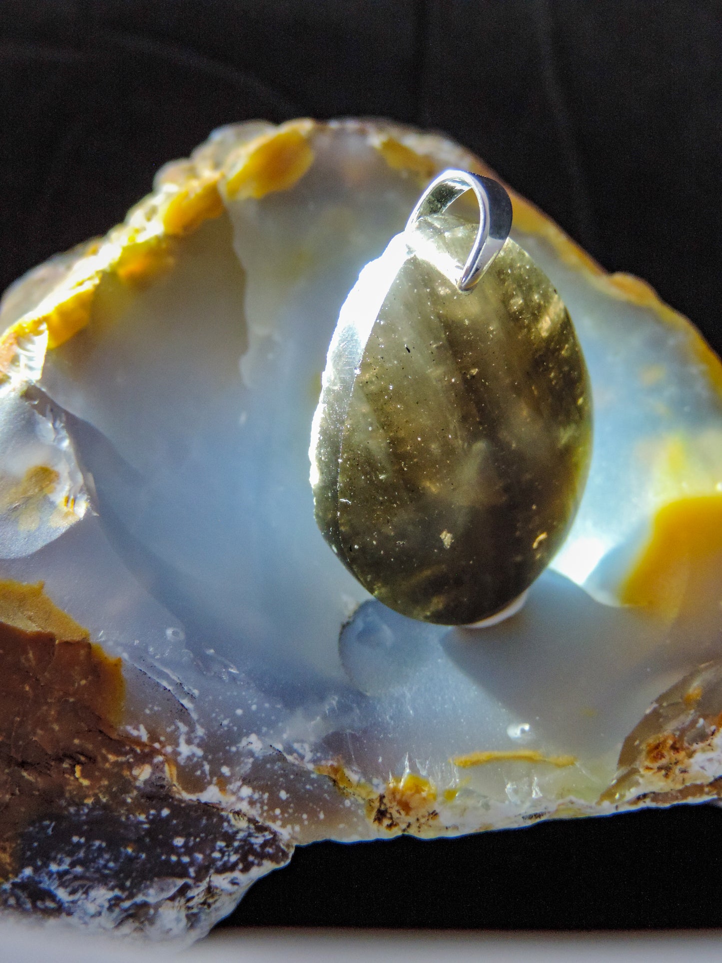 The Agni Manitite pendants on our store are unique in design. One side is smooth and polished while the other side looks rough and irregular, a representation of its natural state. The pendant can be worn with either side facing out. The bail is authentic 925 sterling silver.