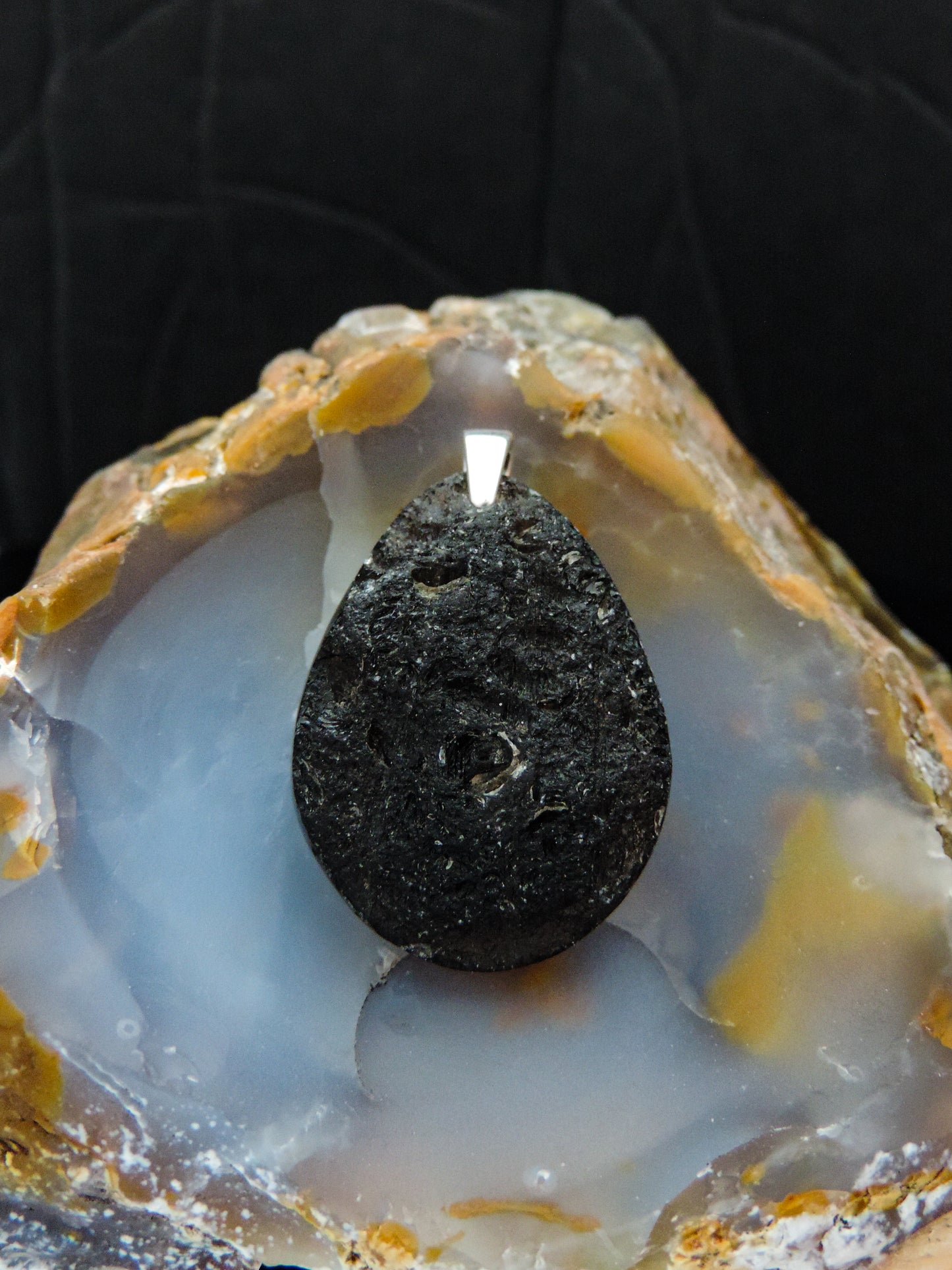 The Agni Manitite pendants on our store are unique in design. One side is smooth and polished while the other side looks rough and irregular, a representation of its natural state. The pendant can be worn with either side facing out. The bail is authentic 925 sterling silver.