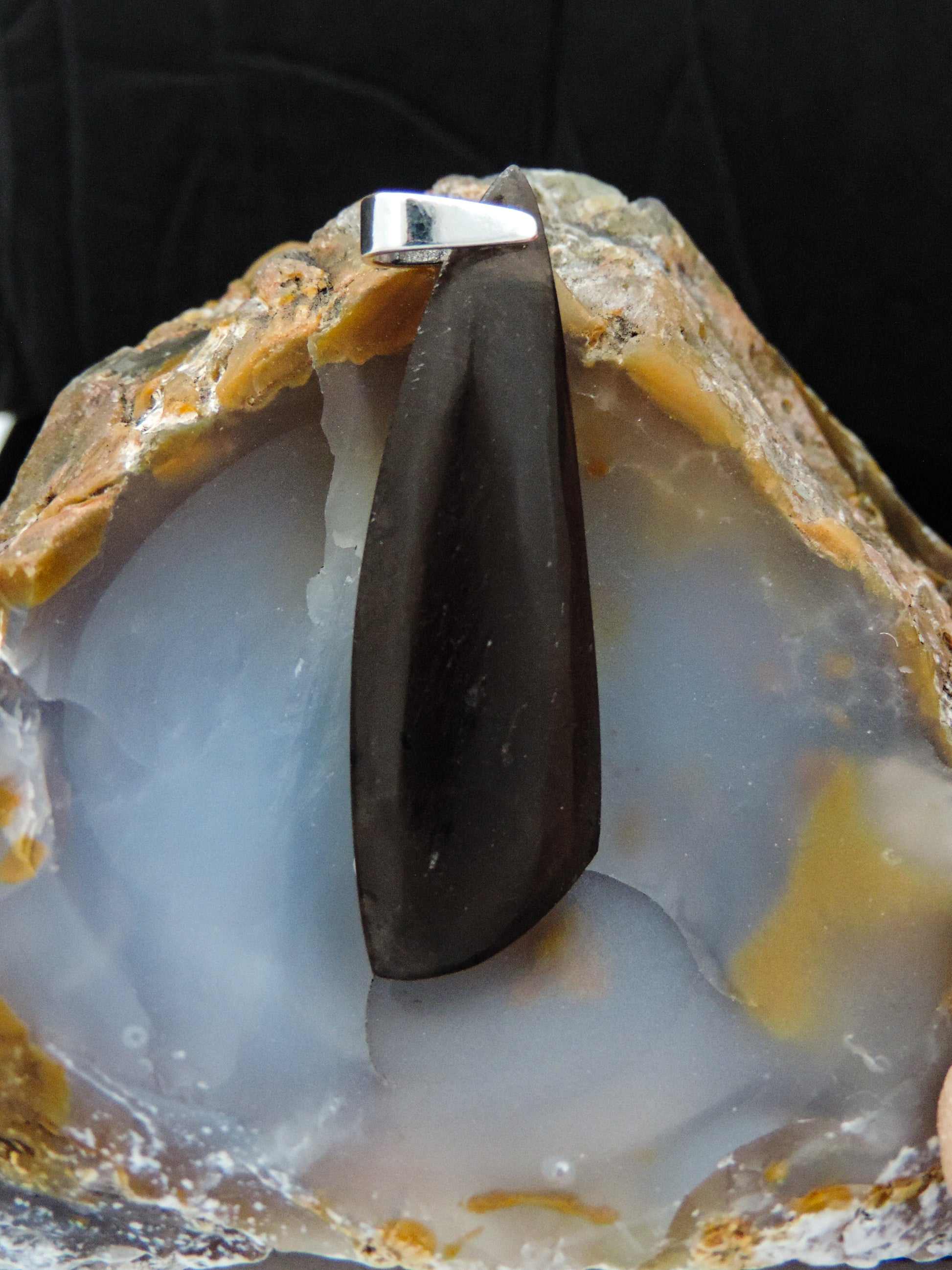 Agni Manitite and Sterling Silver Pendant.  The Agni Manitite pendants on our store are unique in design.  One side is smooth and polished while the other side looks rough and irregular, a representation of its natural state.