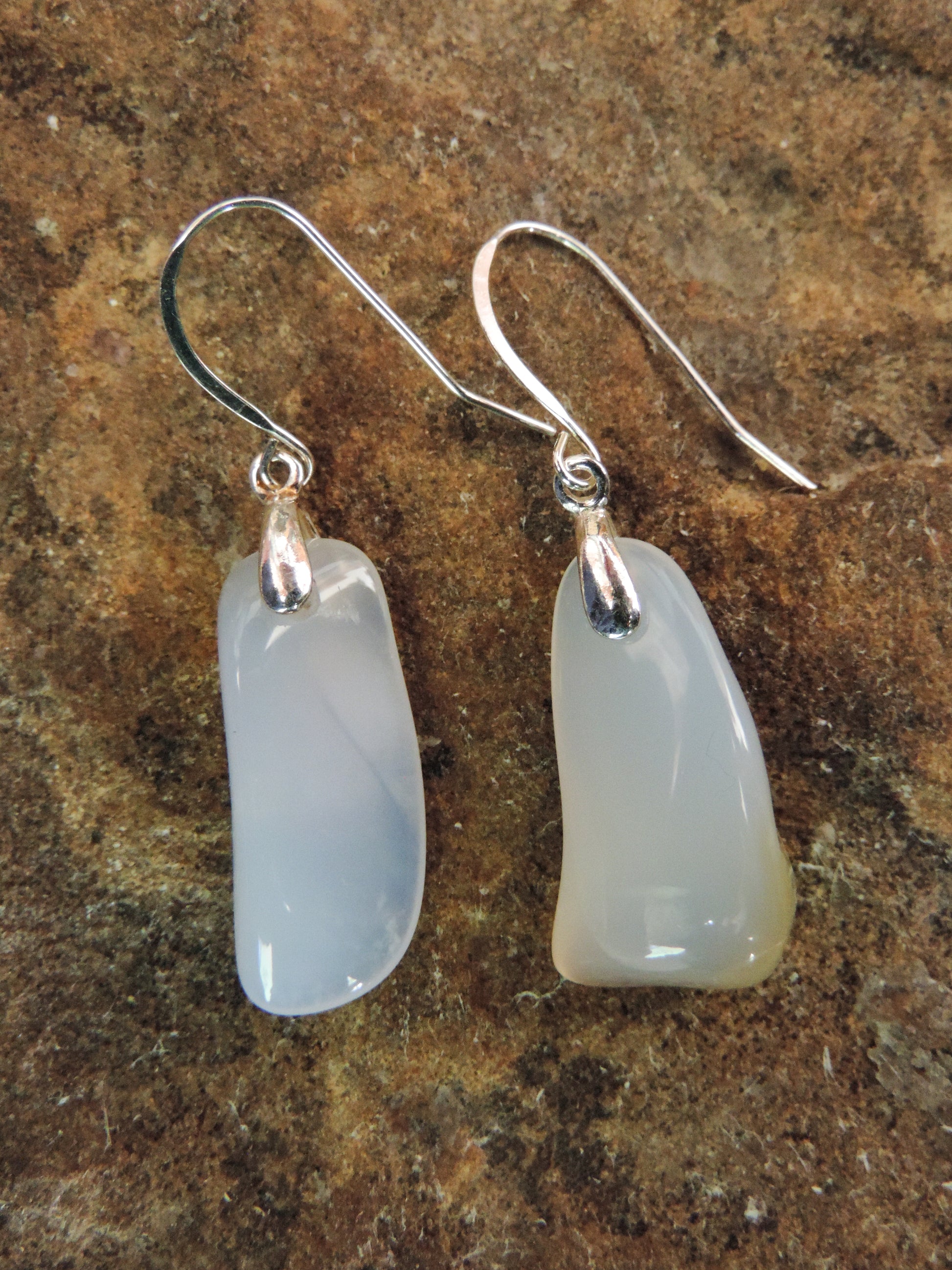 The bail and earring wires are authentic 925 sterling silver.  Wear these original earrings and stand out in a crowd!  Known as the Treasure State, Montana’s landscape is an abundant resource for precious and semi-precious stones.  One of the semi-precious stones, Madison Blue Agate, are featured in these earrings.