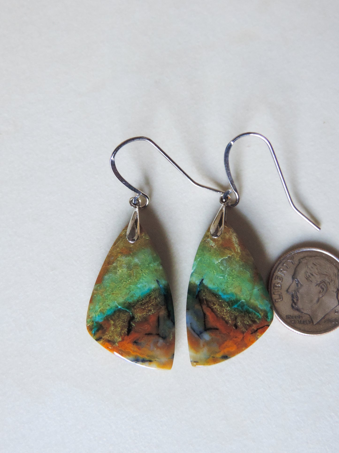 The bail and earring wires are authentic 925 sterling silver. Feel treasured when you wear these earrings! Extremely rare and lovely, Indonesian Blue Opalized Wood is a cherished material used by lapidary artists for creating stunning pieces of jewelry. The material was first found as pebbles and rounded stones in streams and near the slopes of three volcanoes in the West Java Province.