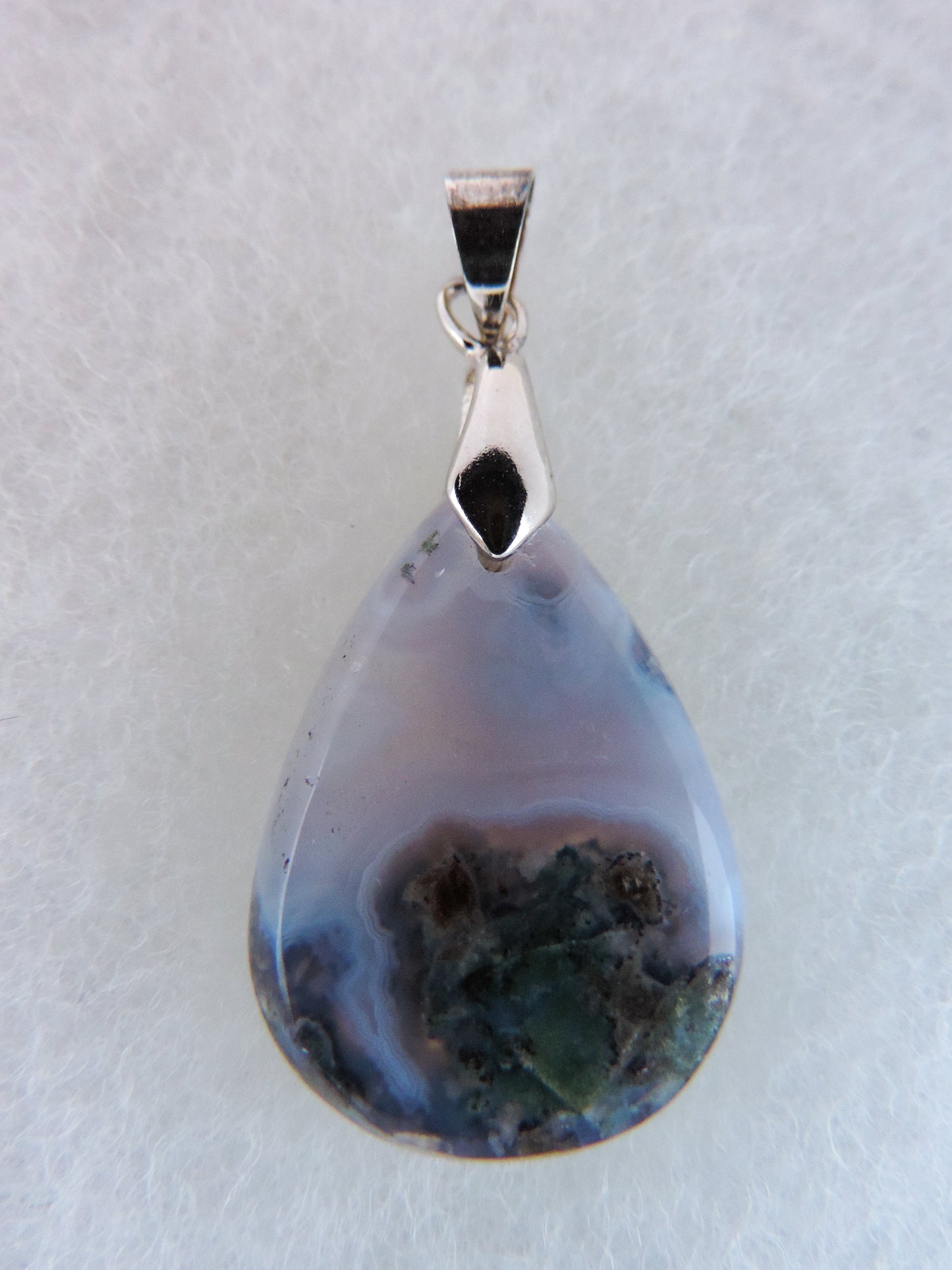 Purple Moss Agate Pendant. Purple gemstones hold significant and powerful spiritual qualities. Purple has been associated with wealth, passion, ambition, magic, awareness, mystery, tranquility, inspiration, understanding, calmness and wisdom to name a few.