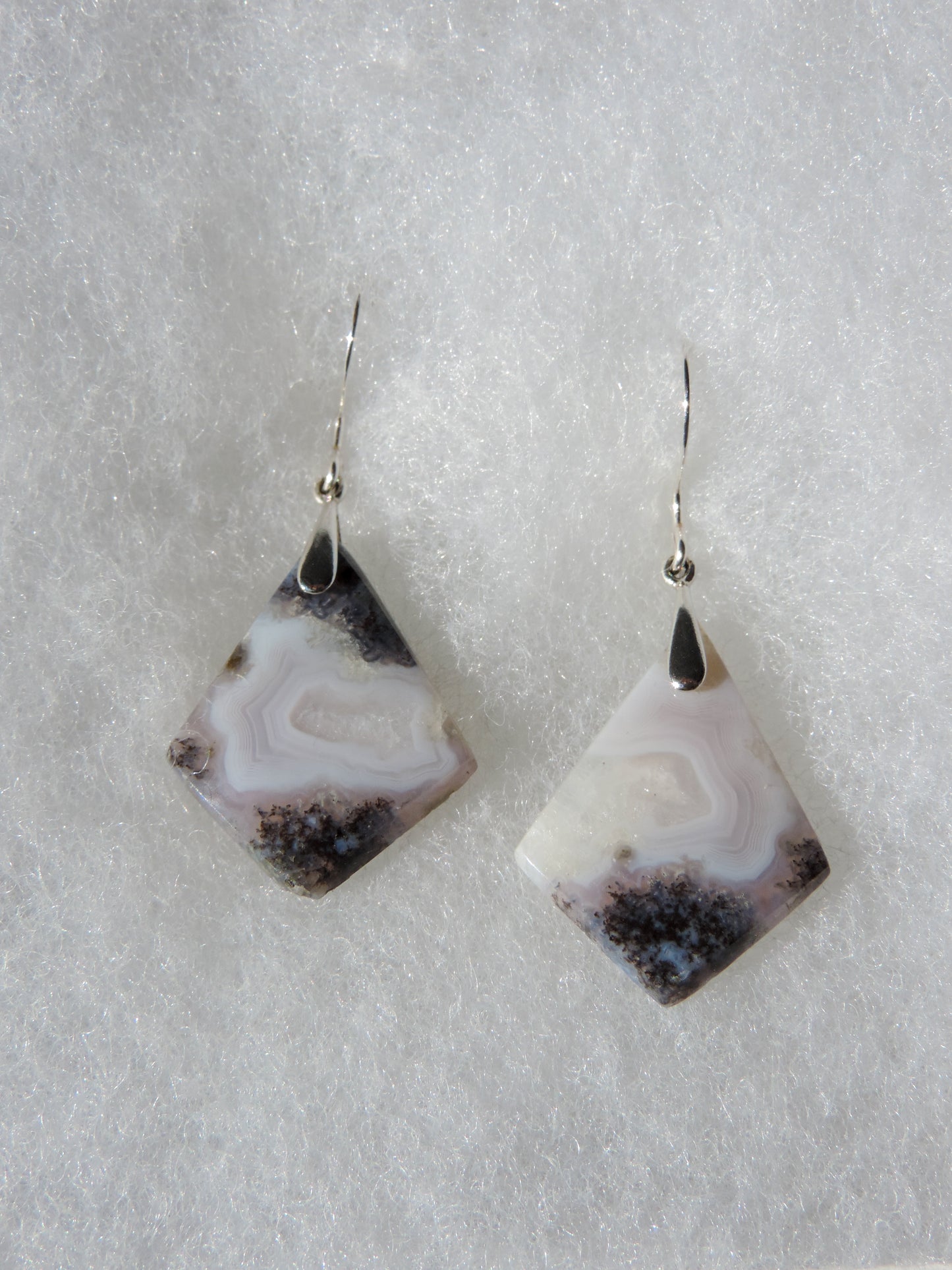 Purple Moss Agate & Sterling Silver Earrings Purple gemstones hold significant and powerful spiritual qualities. Purple has been associated with wealth, passion, ambition, magic, awareness, mystery, tranquility, inspiration, understanding, calmness and wisdom to name a few.
