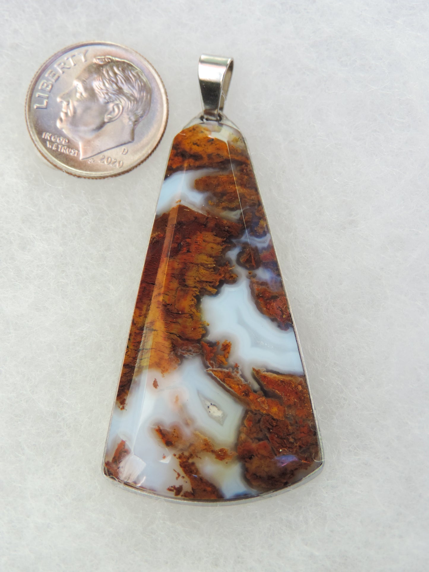 Find your perfect Indonesian Agate on our store! Our hand crafted jewelry pendant is photographed next to a ruler for size. It was photographed without filters on automatic setting in natural light; however, slight color variations may occur due to digitization.
