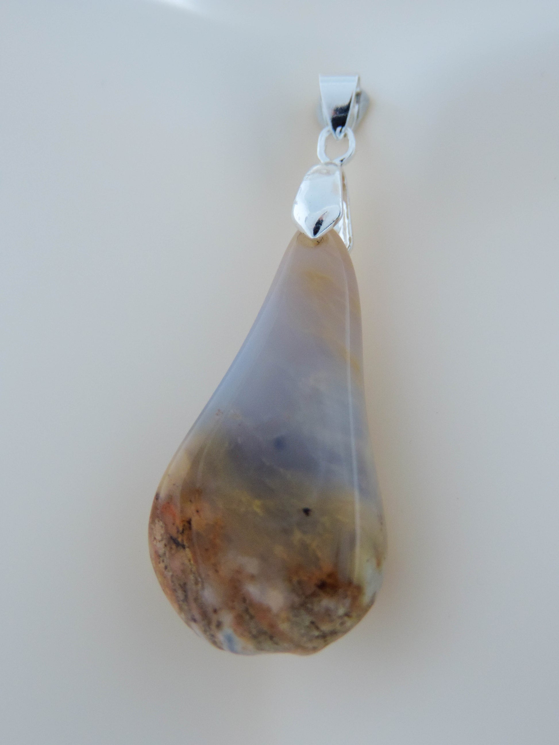 This rare stone is found in only a few locations in Montana, our material is hand collected on private property in the mountains and carried out in backpacks...each piece worth its weight in every step!  The translucent blue agate and its color variations have an alluring effect, many people find the blue agate a relaxing, calming and peaceful stone to wear.  Original and unique in design, each piece is hand crafted by lapidary artists in Montana.
