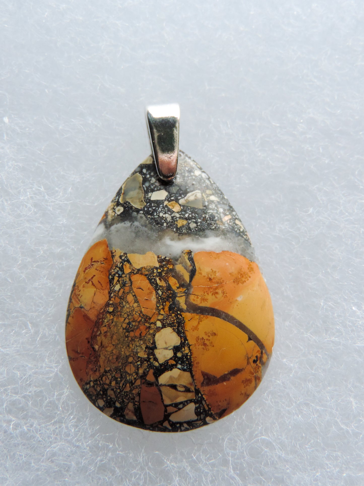 Exquisite in appearance, this Maligano Jasper & Sterling Silver Pendant will compliment your formal or casual attire. The pendant bail is authentic 925 sterling silver. Our hand crafted jewelry pendant is photographed next to a ruler for size.