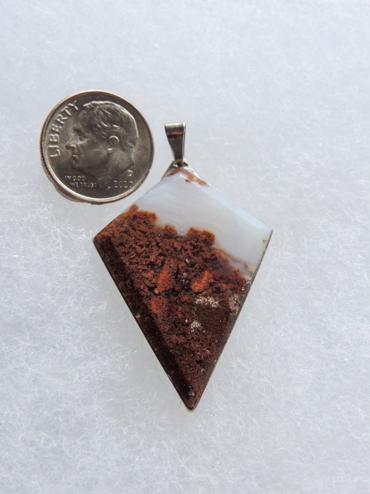 Find your perfect Indonesian Agate on our store Our hand crafted jewelry pendant is photographed next to an item for size comparison. They are photographed without filters on automatic setting in natural light; however, slight color variations may occur due to digitization. Natural stones can have nooks and crannies, inclusions or small cracks, these distinguishing features lend character to the piece.