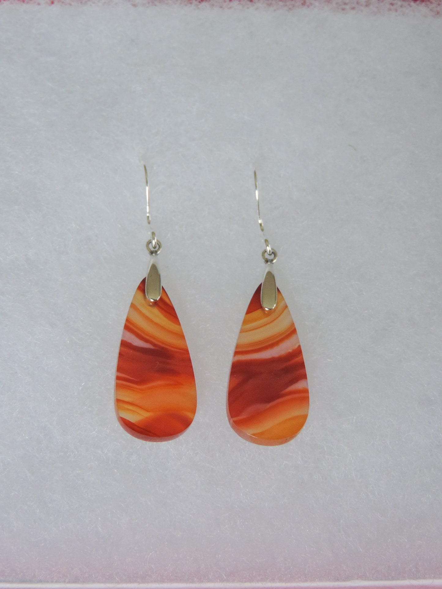 Carnelian Agate & Sterling Silver Earrings. Indonesian Agates exhibit a wide variety of colors and amazing complexity. No two agates are exactly alike, each one being a unique and beautiful creation! Agates with multiple bands of color are known as fortification agates, those with dendritic or moss looking inclusions are referred to as moss agate and many others are given descriptive names relative to their appearance or where they are found.