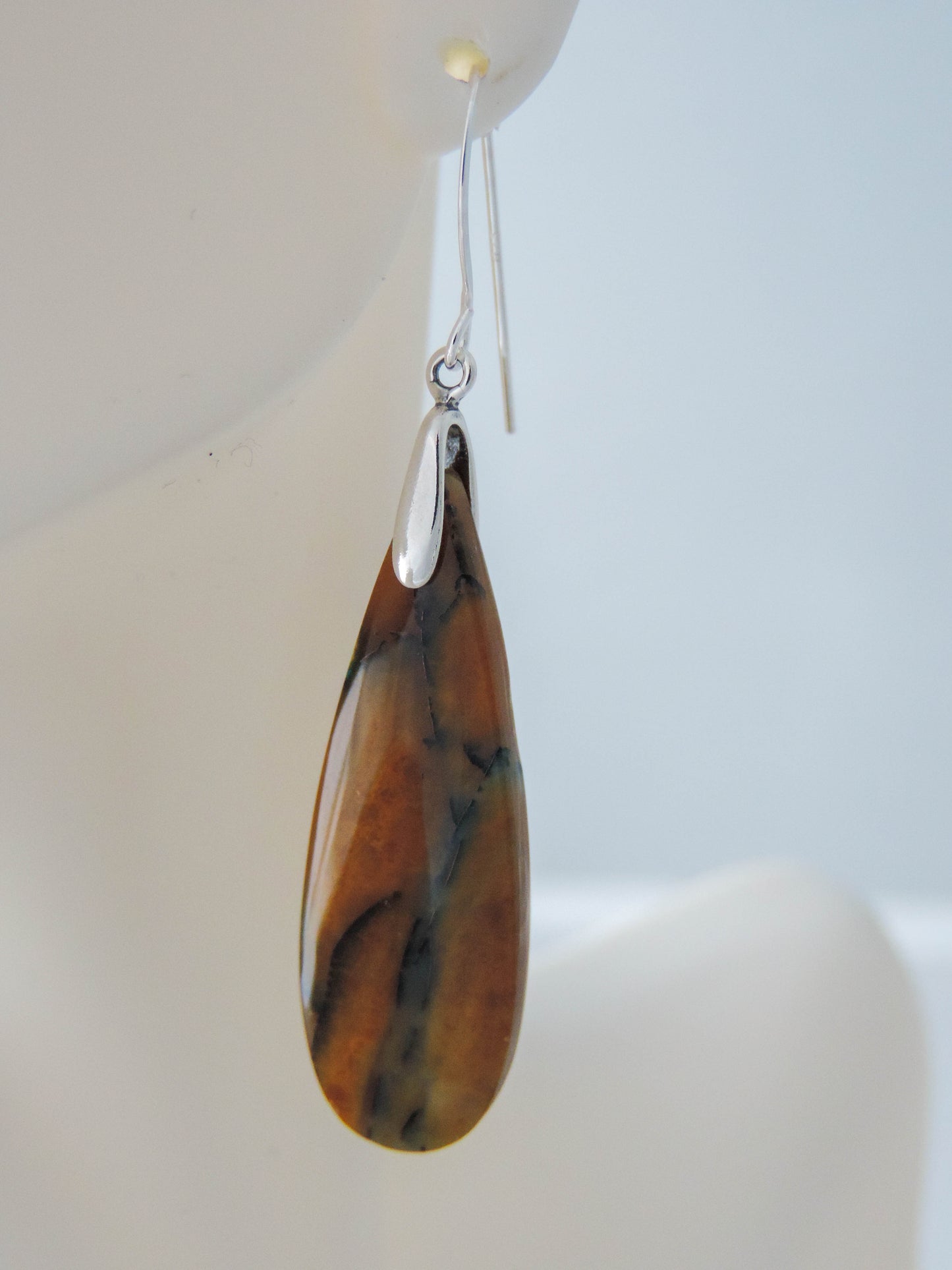 The bail and earring wires are authentic 925 sterling silver. Feel treasured when you wear these earrings! Extremely rare and lovely, Indonesian Blue Opalized Wood is a cherished material used by lapidary artists for creating stunning pieces of jewelry. The material was first found as pebbles and rounded stones in streams and near the slopes of three volcanoes in the West Java Province.