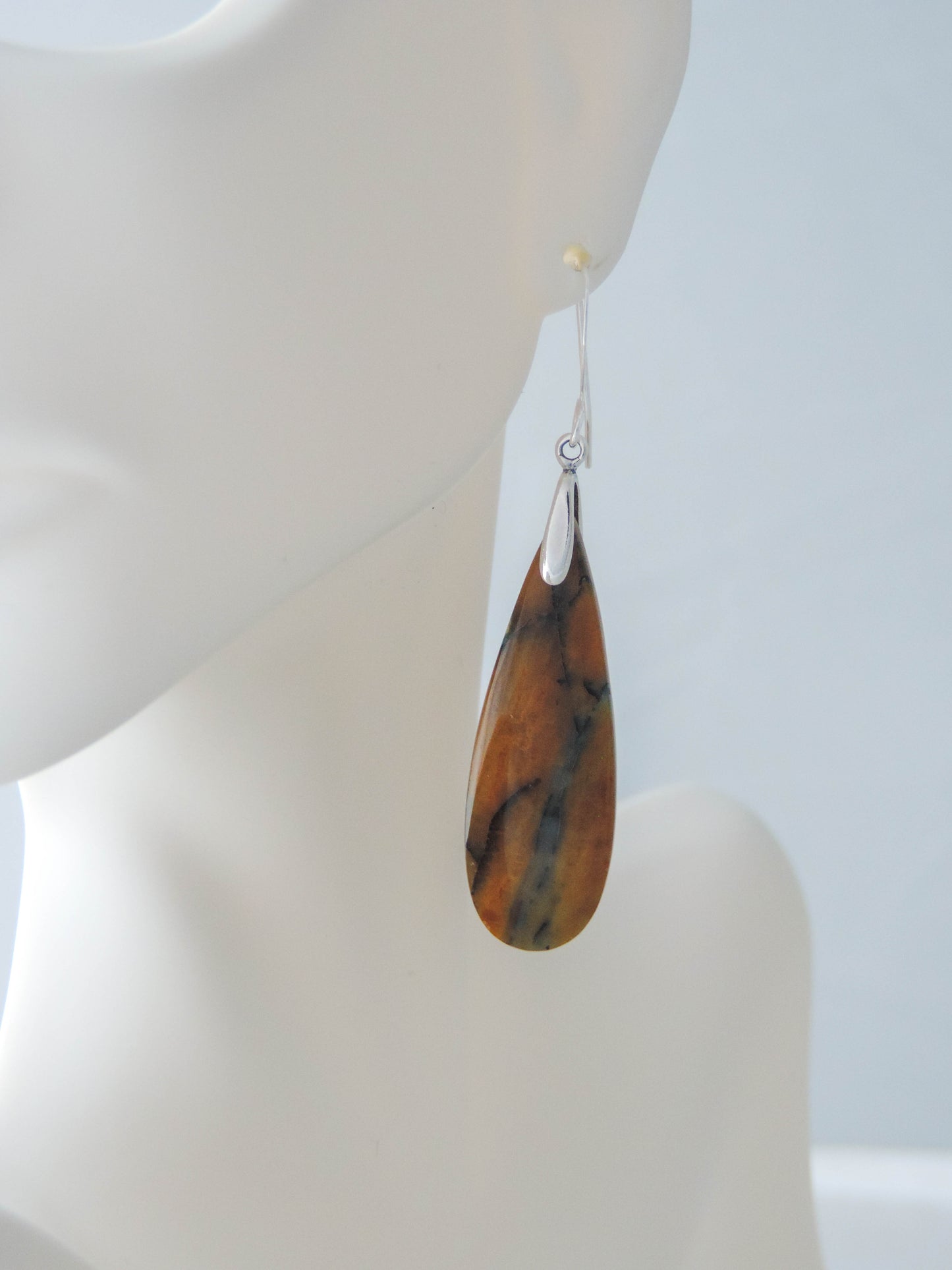 The bail and earring wires are authentic 925 sterling silver. Feel treasured when you wear these earrings! Extremely rare and lovely, Indonesian Blue Opalized Wood is a cherished material used by lapidary artists for creating stunning pieces of jewelry. The material was first found as pebbles and rounded stones in streams and near the slopes of three volcanoes in the West Java Province.
