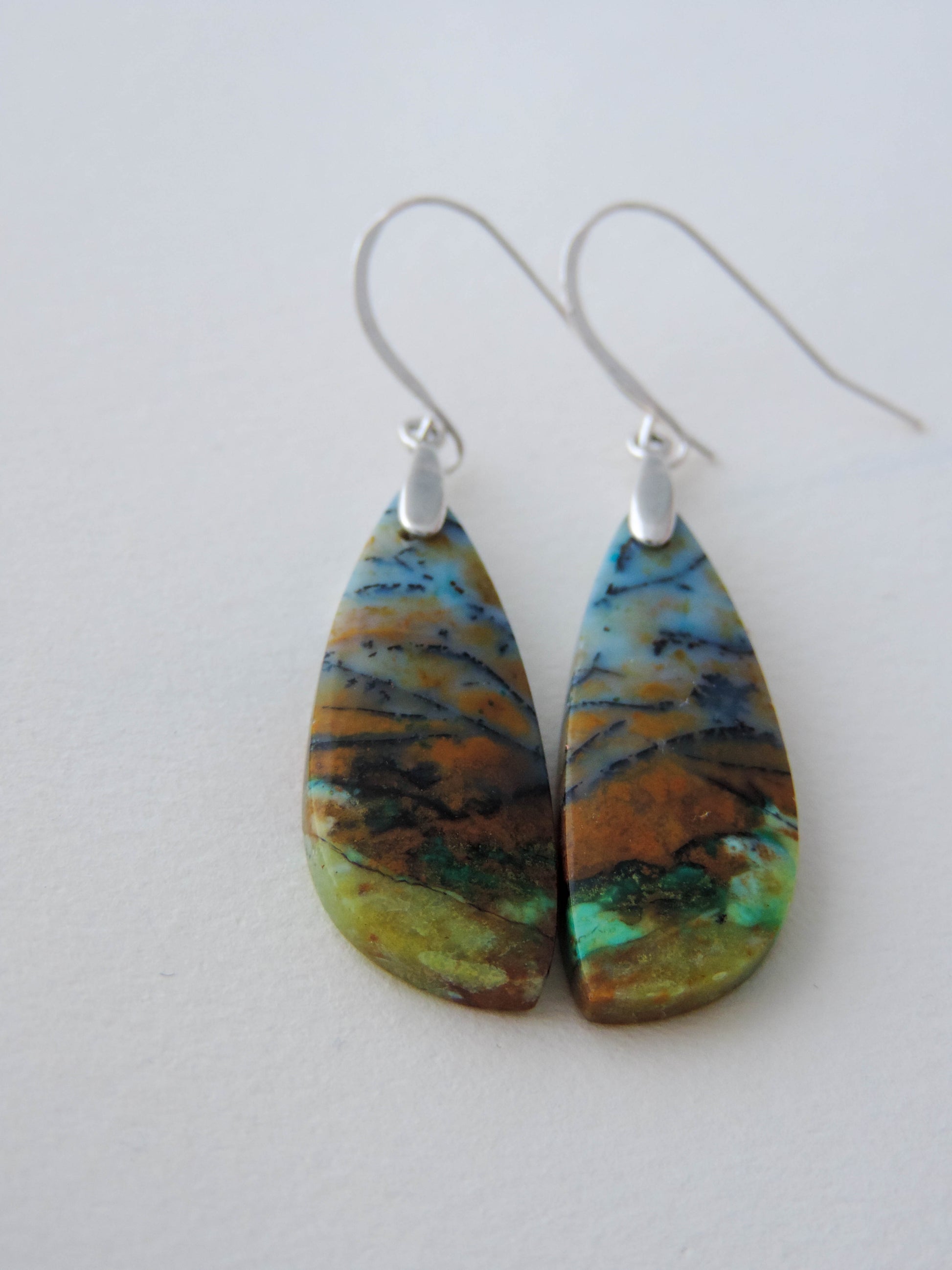 Indonesian Blue Opalized Wood & Sterling Silver Earrings  Extremely rare and lovely, Indonesian Blue Opalized Wood is a cherished material used by lapidary artists for creating stunning pieces of jewelry.