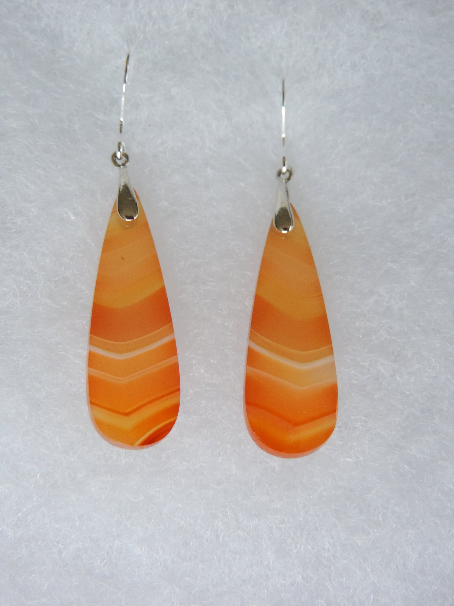 Carnelian Agate & Sterling Silver Earrings. Indonesian Carnelian Agates exhibit a wide variety of colors and amazing complexity. No two agates are exactly alike, each one being a unique and beautiful creation! Agates with multiple bands of color are known as fortification agates, those with dendritic or moss looking inclusions are referred to as moss agate and many others are given descriptive names relative to their appearance or where they are found.