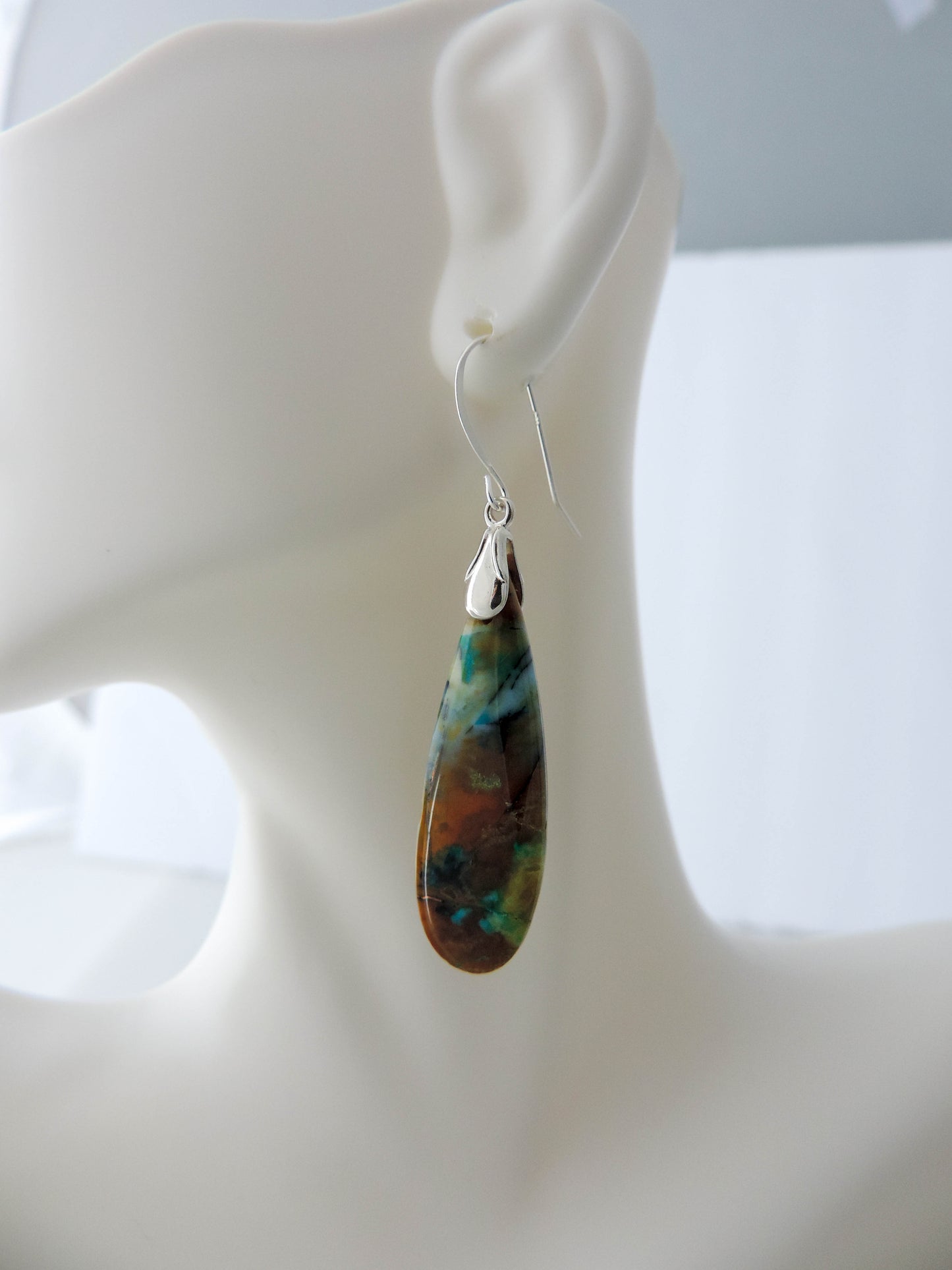 The bail and earring wires are authentic 925 sterling silver. Feel treasured when you wear these earrings!Extremely rare and lovely, Indonesian Blue Opalized Wood is a cherished material used by lapidary artists for creating stunning pieces of jewelry. The material was first found as pebbles and rounded stones in streams and near the slopes of three volcanoes in the West Java Province.