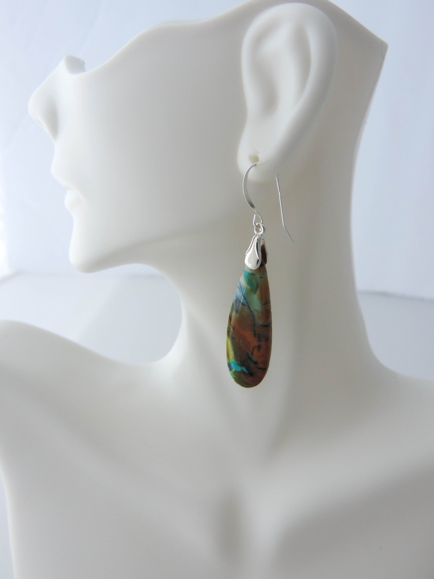 The bail and earring wires are authentic 925 sterling silver. Feel treasured when you wear these earrings!Extremely rare and lovely, Indonesian Blue Opalized Wood is a cherished material used by lapidary artists for creating stunning pieces of jewelry. The material was first found as pebbles and rounded stones in streams and near the slopes of three volcanoes in the West Java Province.