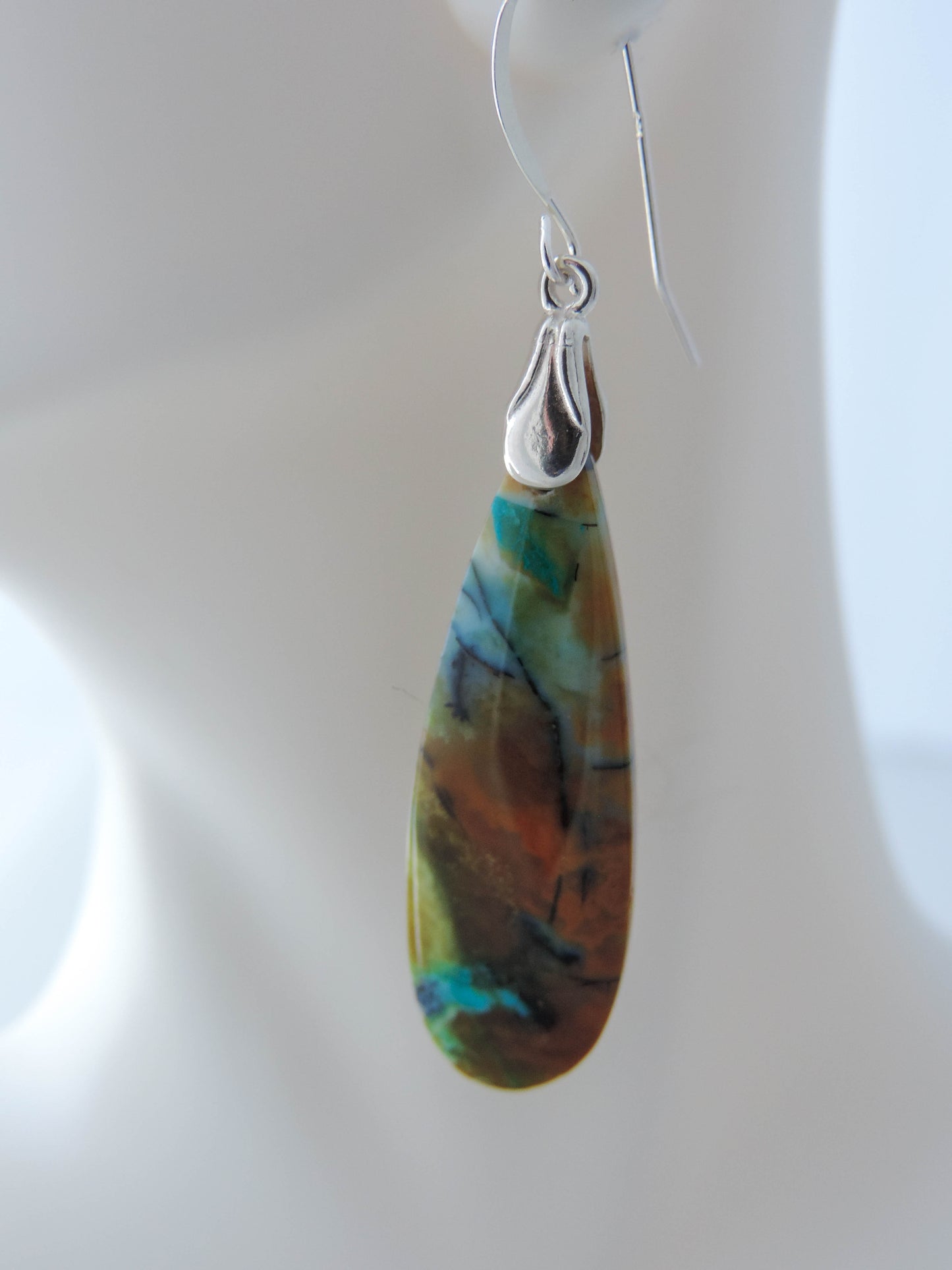 The bail and earring wires are authentic 925 sterling silver. Feel treasured when you wear these earrings!Extremely rare and lovely, Indonesian Blue Opalized Wood is a cherished material used by lapidary artists for creating stunning pieces of jewelry. The material was first found as pebbles and rounded stones in streams and near the slopes of three volcanoes in the West Java Province.