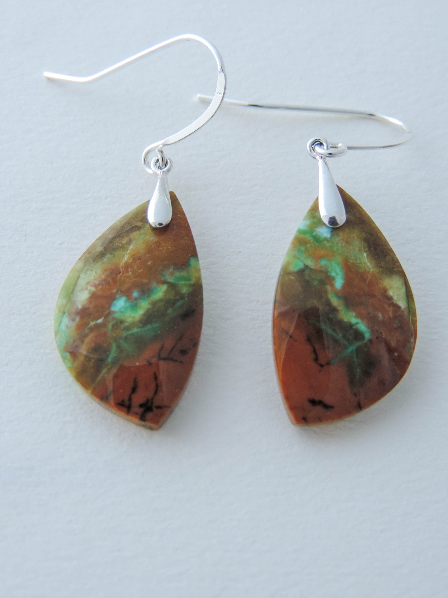 Indonesian Blue Opalized Wood & Sterling Silver Earrings Extremely rare and lovely, Indonesian Blue Opalized Wood is a cherished material used by lapidary artists for creating stunning pieces of jewelry. The material was first found as pebbles and rounded stones in streams and near the slopes of three volcanoes in the West Java Province