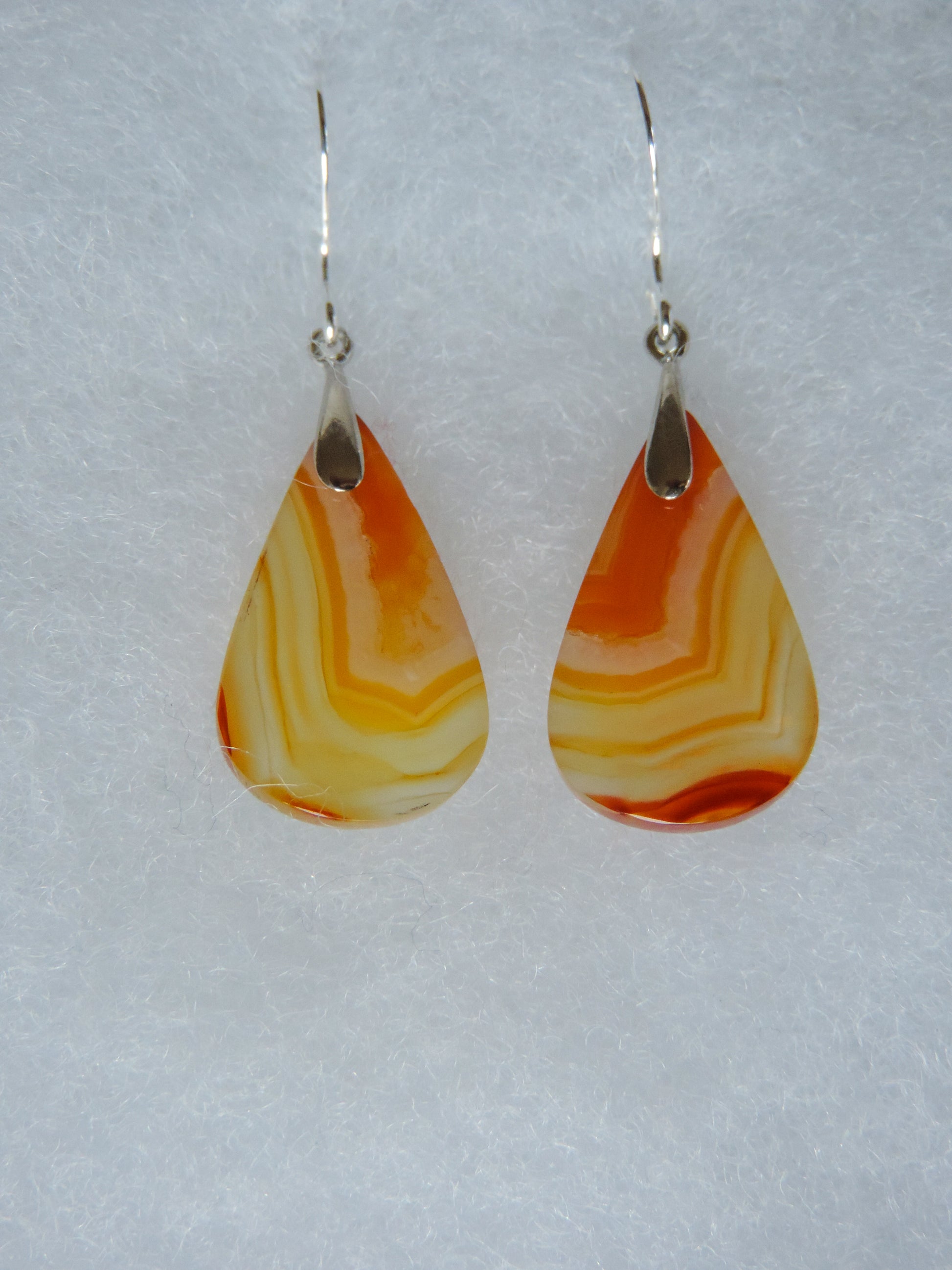 Carnelian Agate & Sterling Silver Earrings.  Indonesian Carnelian Agates exhibit a wide variety of colors and amazing complexity.  No two agates are exactly alike, each one being a unique and beautiful creation!  Agates with multiple bands of color are known as fortification agates, those with dendritic or moss looking inclusions are referred to as moss agate and many others are given descriptive names relative to their appearance or where they are found.