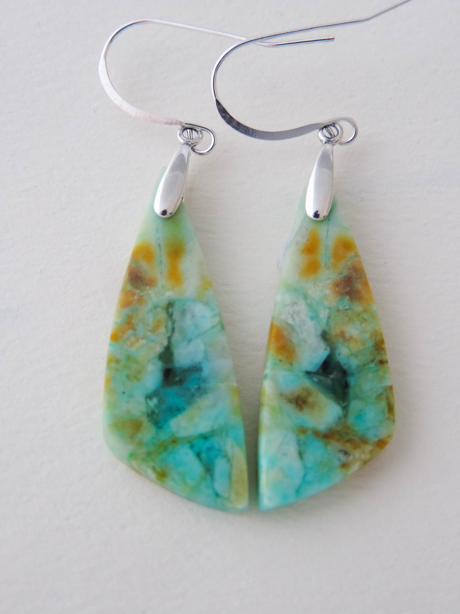 Indonesian Blue Opalized Wood Earrings with Sterling Silver. Extremely rare and lovely, Indonesian Blue Opalized Wood is a cherished material used by lapidary artists for creating stunning pieces of jewelry.  The material was first found as pebbles and rounded stones in streams and near the slopes of three volcanoes in the West Java Province.