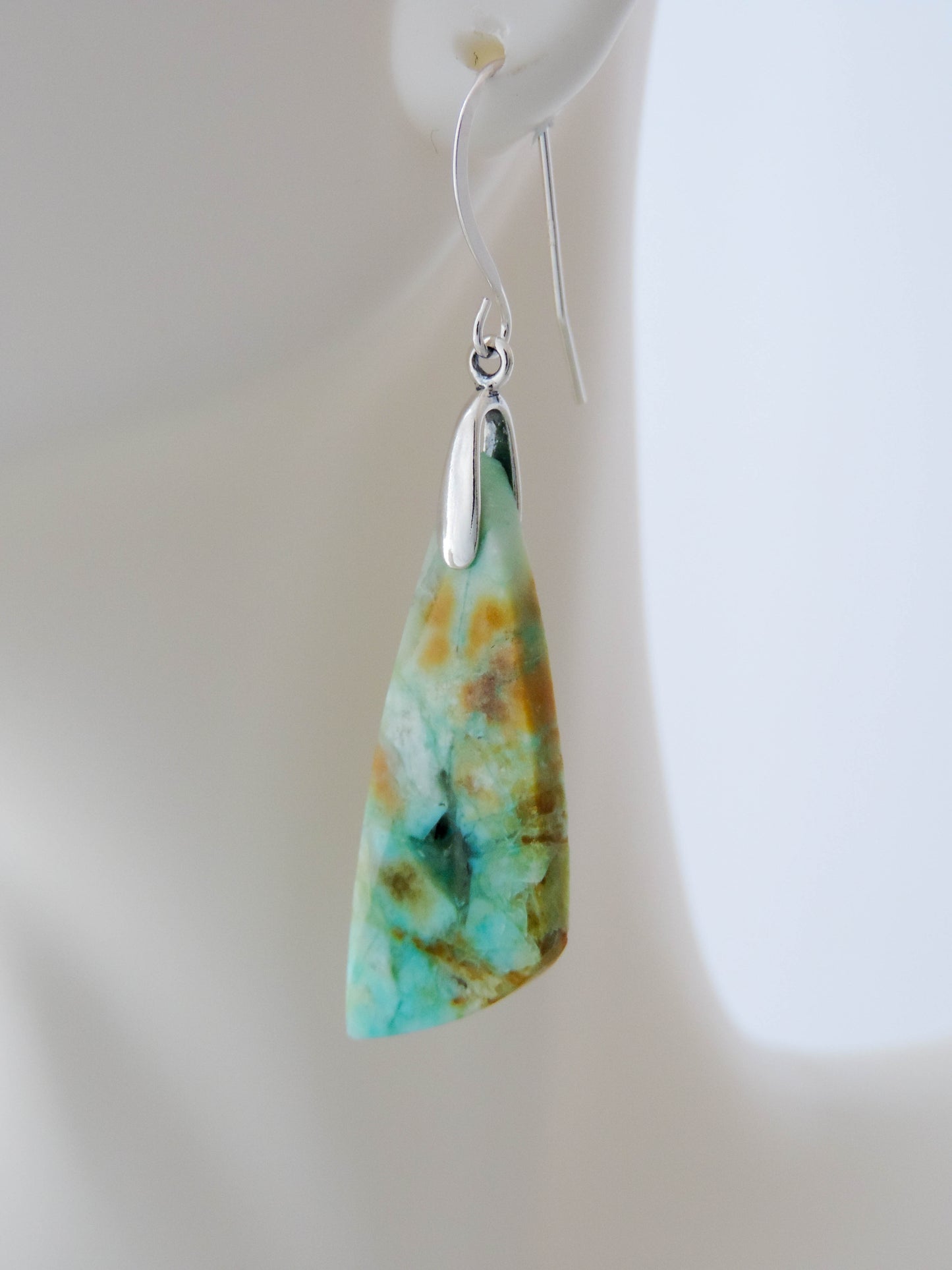 Indonesian Blue Opalized Wood Earrings with Sterling Silver. Extremely rare and lovely, Indonesian Blue Opalized Wood is a cherished material used by lapidary artists for creating stunning pieces of jewelry.  The material was first found as pebbles and rounded stones in streams and near the slopes of three volcanoes in the West Java Province.