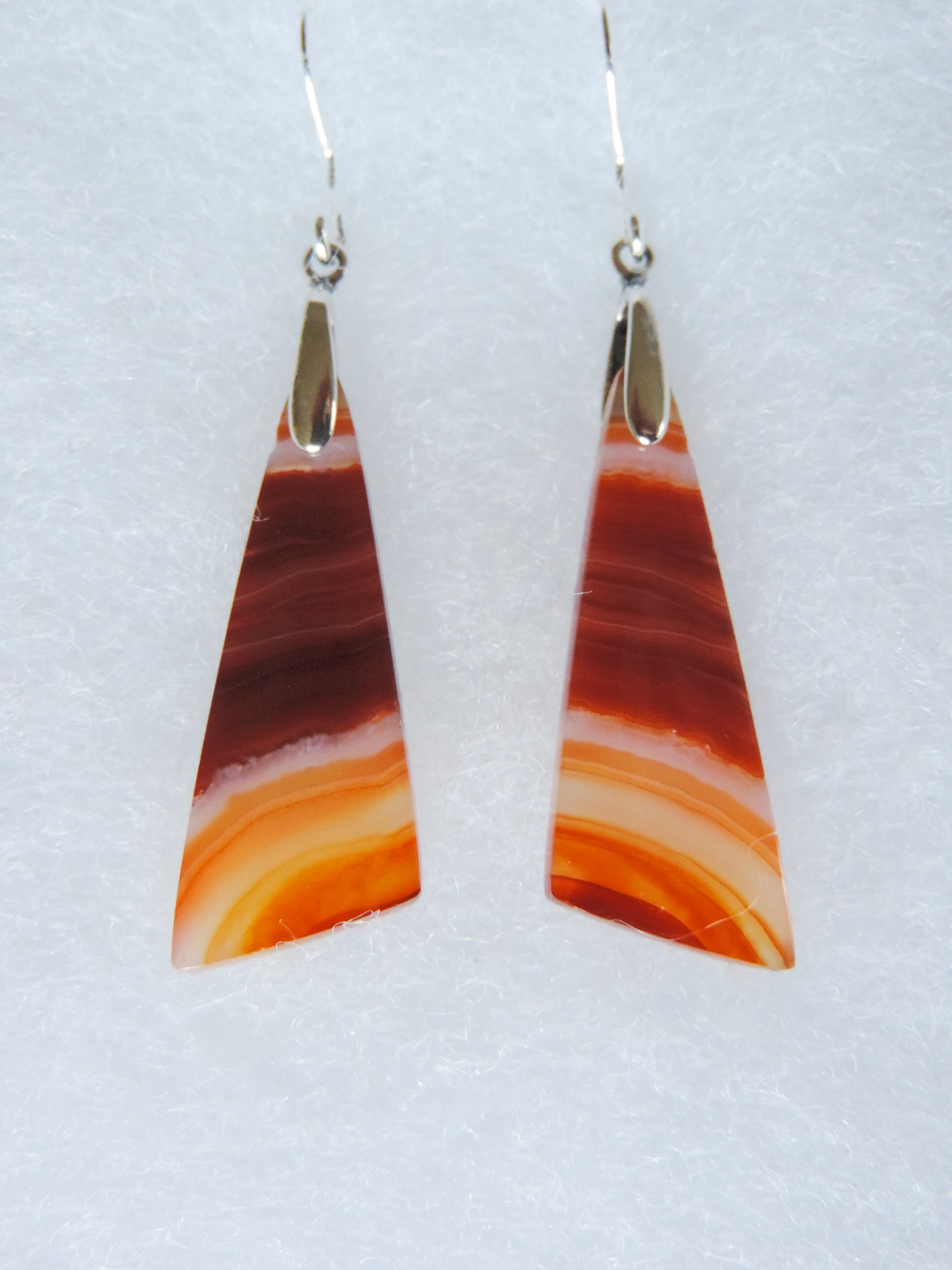 Carnelian Agate & Sterling Silver Earrings.  Indonesian Agates exhibit a wide variety of colors and amazing complexity.  No two agates are exactly alike, each one being a unique and beautiful creation!  Agates with multiple bands of color are known as fortification agates, those with dendritic or moss looking inclusions are referred to as moss agate and many others are given descriptive names relative to their appearance or where they are found.