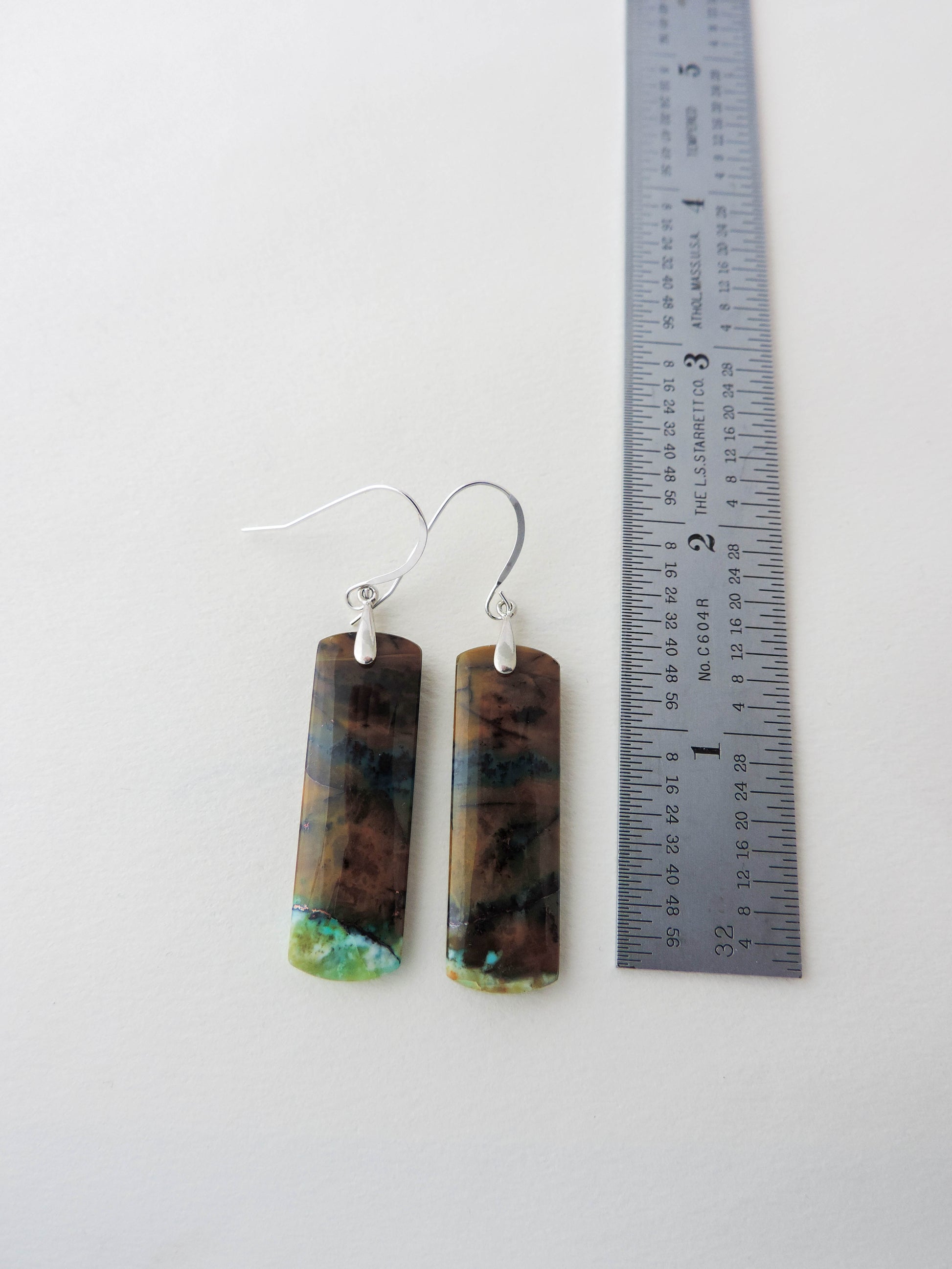 Indonesian Blue Opalized Wood Earrings with Sterling Silver really beautifully hand crafted!! Extremely rare and lovely, Indonesian Blue Opalized Wood is a cherished material used by lapidary artists for creating stunning pieces of jewelry.  The material was first found as pebbles and rounded stones in streams and near the slopes of three volcanoes in the West Java Province.