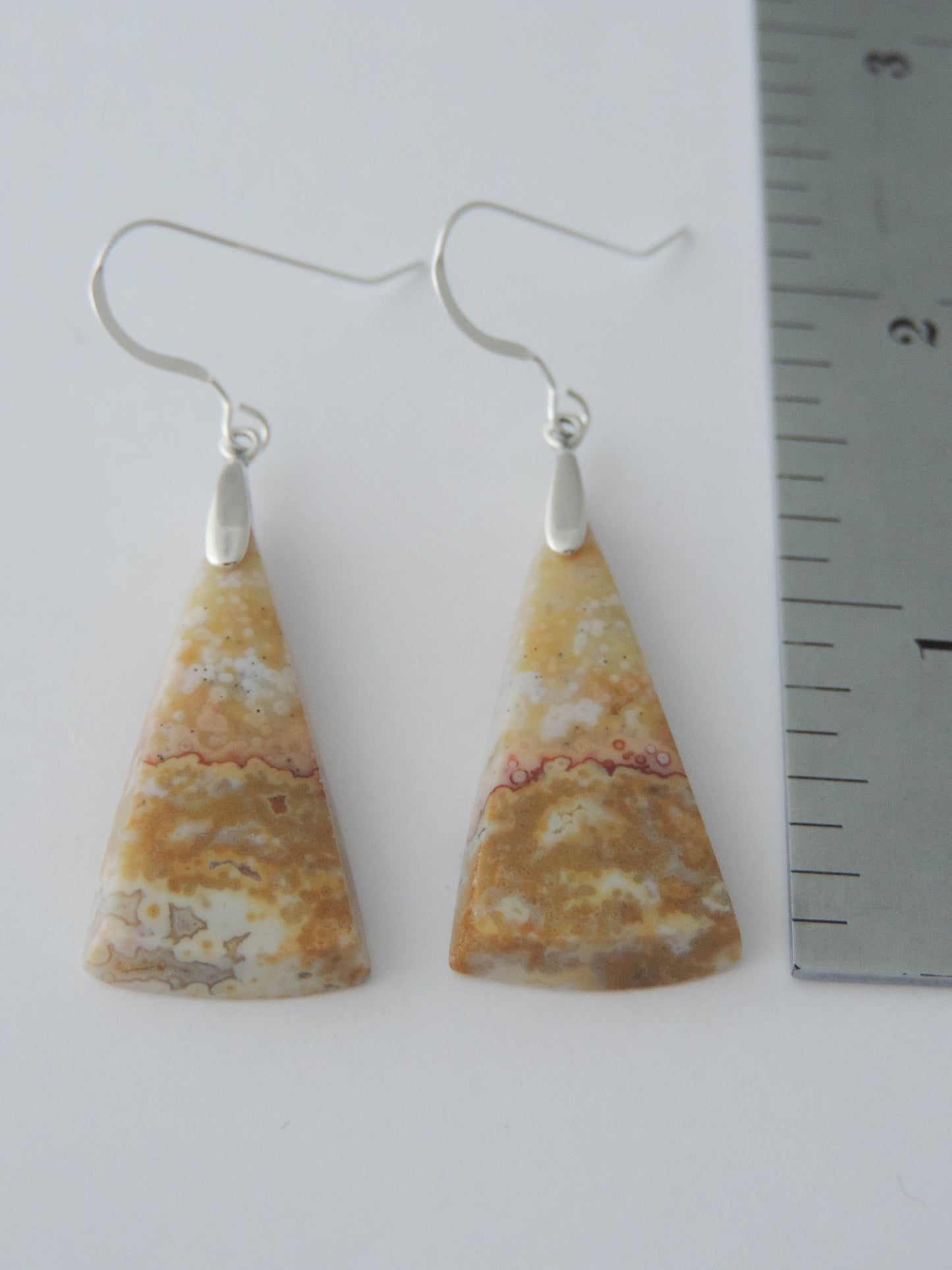 Our hand crafted jewelry earrings are photographed next to a ruler for size. This stone is a natural color, no dyes or heat treatment have been used.