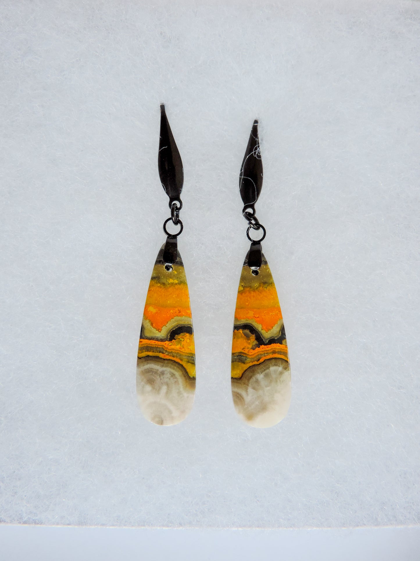 Bumblebee Jasper is named for its yellow, white, orange and black colored banding which resembles a common bumblebee.  This mineral was discovered in the Papandayan Volcano, West Java Province, Indonesia.  The gemstone is truly unique in appearance, fun to wear and is known spiritually for its uplifting, radiant energy.