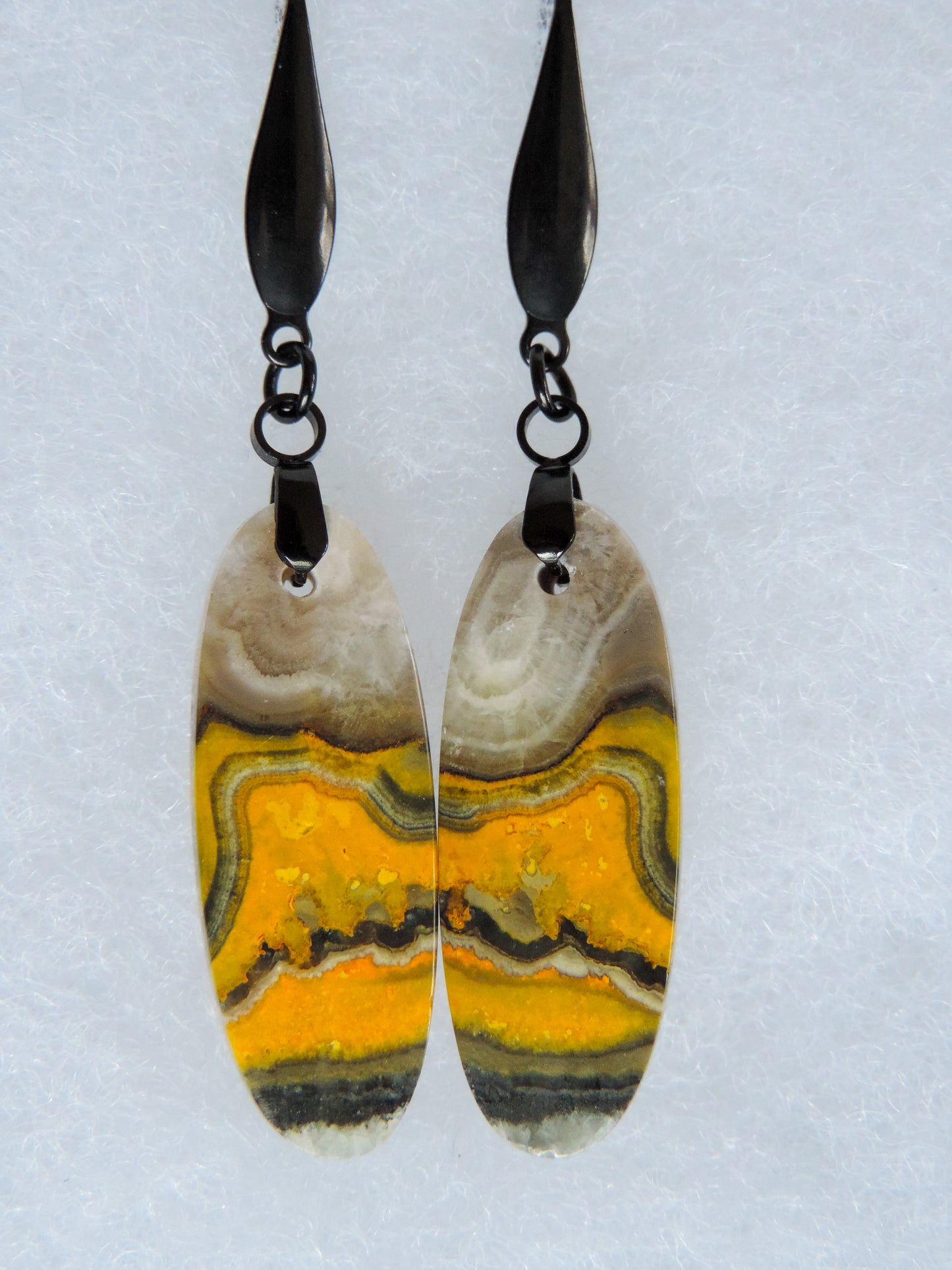 Bumblebee Jasper is named for its yellow, white, orange and black colored banding which resembles a common bumblebee.  This mineral was discovered in the Papandayan Volcano, West Java Province, Indonesia.  The gemstone is truly unique in appearance, fun to wear and is known spiritually for its uplifting, radiant energy.