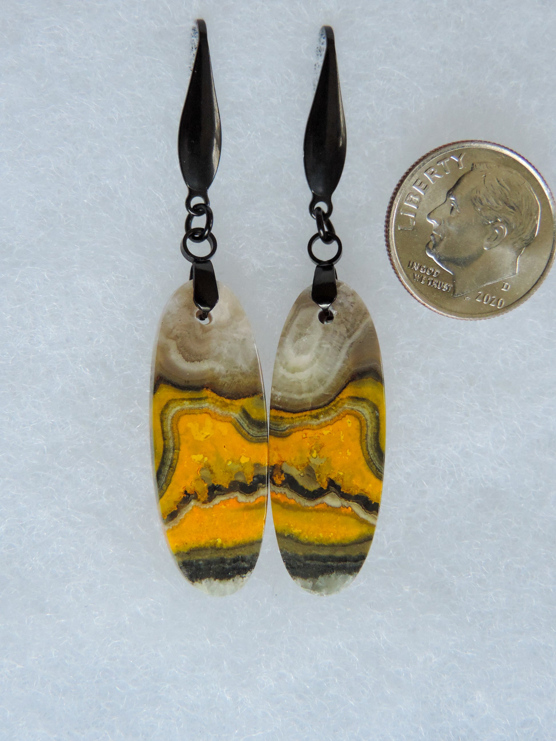 Bumblebee Jasper is named for its yellow, white, orange and black colored banding which resembles a common bumblebee.  This mineral was discovered in the Papandayan Volcano, West Java Province, Indonesia.  The gemstone is truly unique in appearance, fun to wear and is known spiritually for its uplifting, radiant energy.