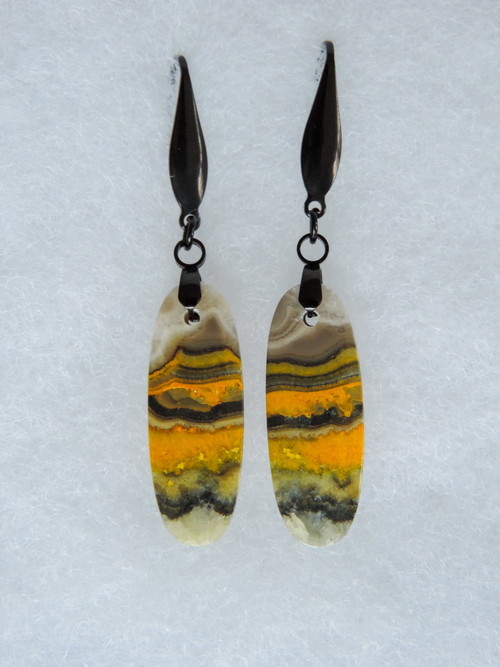 Bumblebee Jasper is named for its yellow, white, orange and black colored banding which resembles a common bumblebee.  This mineral was discovered in the Papandayan Volcano, West Java Province, Indonesia.  The gemstone is truly unique in appearance, fun to wear and is known spiritually for its uplifting, radiant energy.