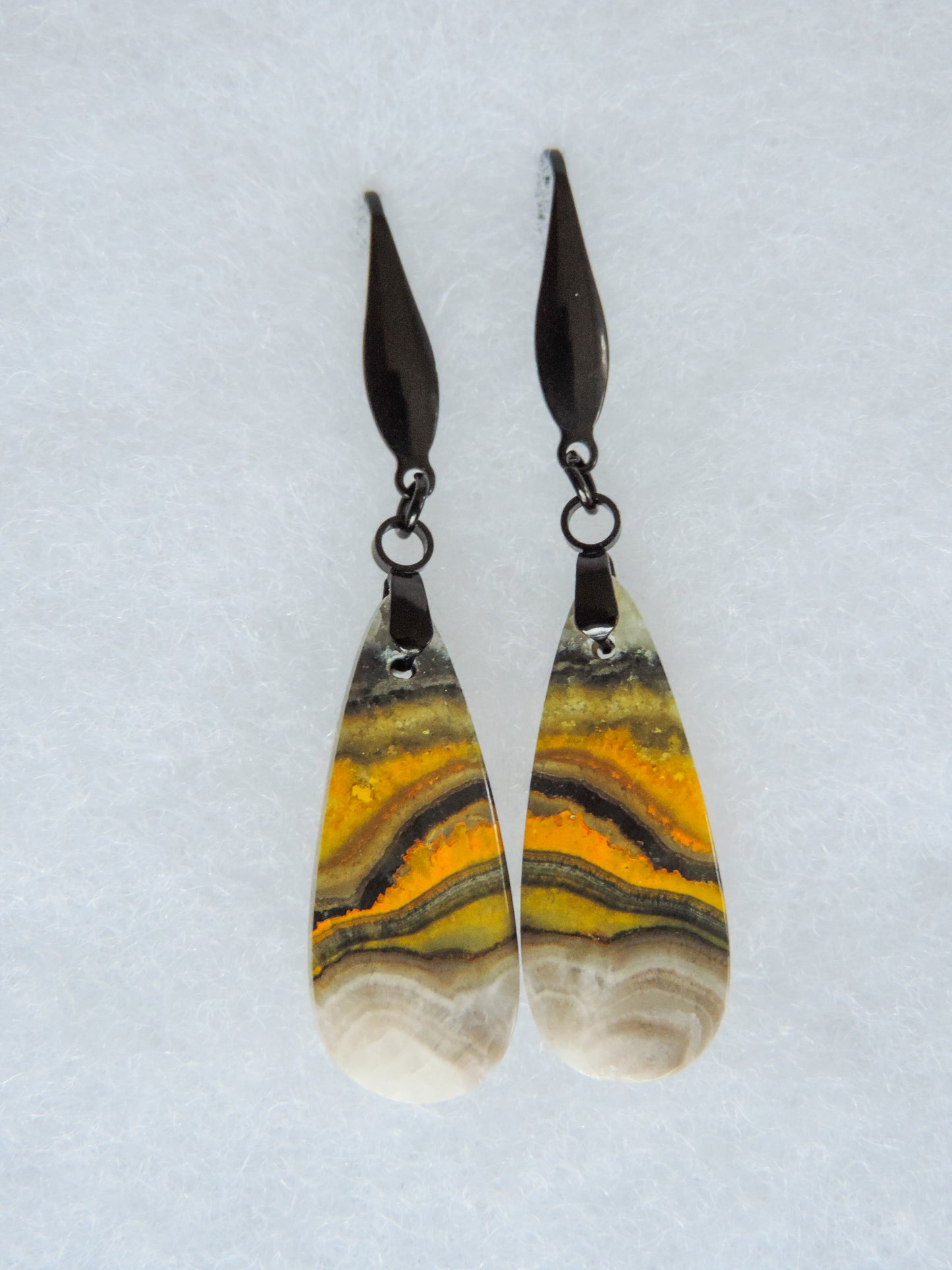 Bumblebee Jasper is named for its yellow, white, orange and black colored banding which resembles a common bumblebee.  This mineral was discovered in the Papandayan Volcano, West Java Province, Indonesia.  The gemstone is truly unique in appearance, fun to wear and is known spiritually for its uplifting, radiant energy.