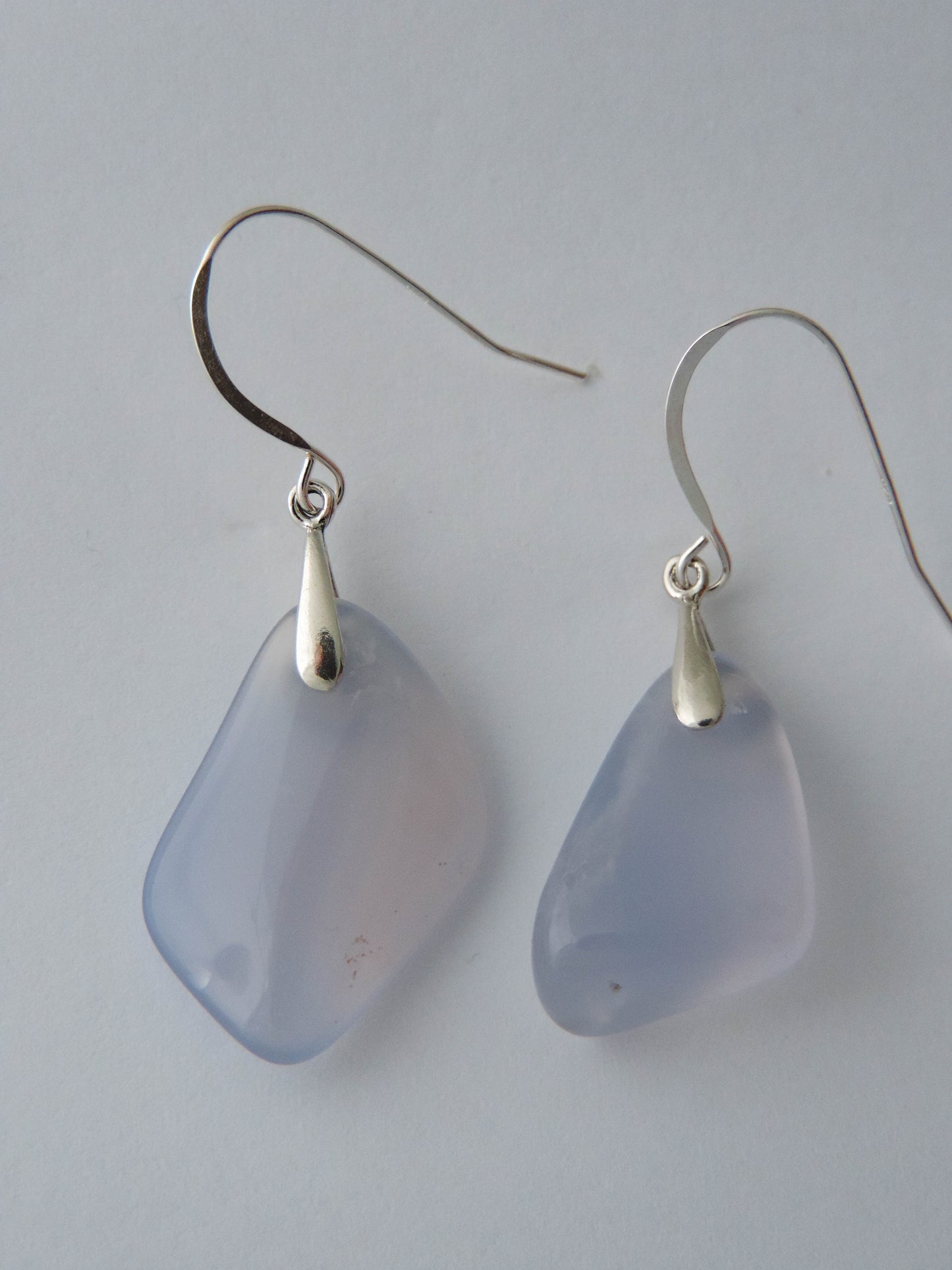 The bail and earring wires are authentic 925 sterling silver.  Wear these original earrings and stand out in a crowd!  Known as the Treasure State, Montana’s landscape is an abundant resource for precious and semi-precious stones.  One of the semi-precious stones, Madison Blue Agate, are featured in these earrings.