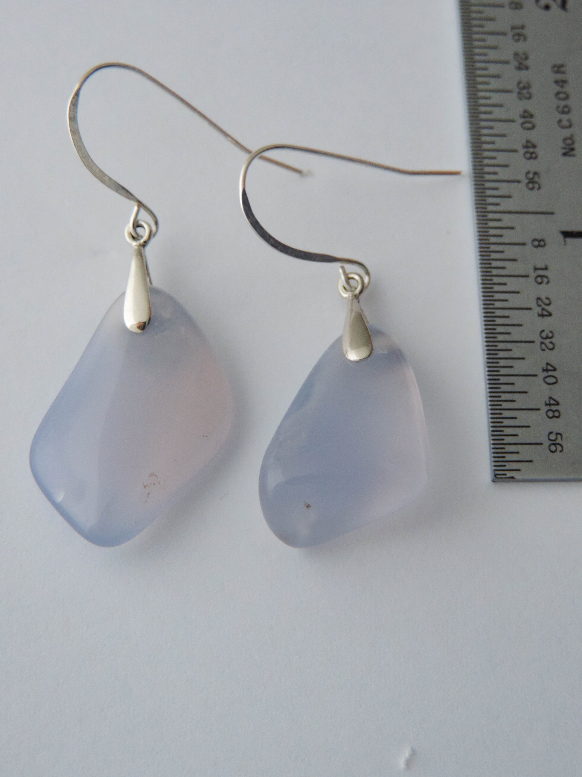 The bail and earring wires are authentic 925 sterling silver.  Wear these original earrings and stand out in a crowd!  Known as the Treasure State, Montana’s landscape is an abundant resource for precious and semi-precious stones.  One of the semi-precious stones, Madison Blue Agate, are featured in these earrings.