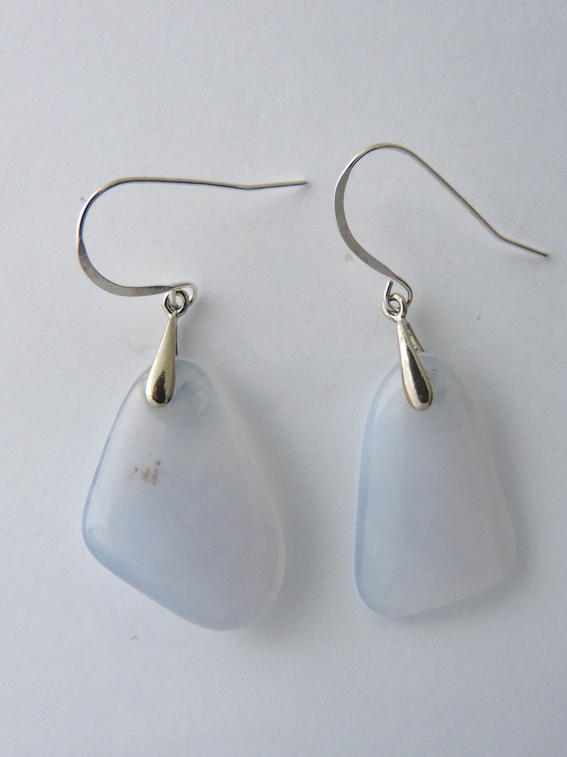 The bail and earring wires are authentic 925 sterling silver.  Wear these original earrings and stand out in a crowd!  Known as the Treasure State, Montana’s landscape is an abundant resource for precious and semi-precious stones.  One of the semi-precious stones, Madison Blue Agate, are featured in these earrings.