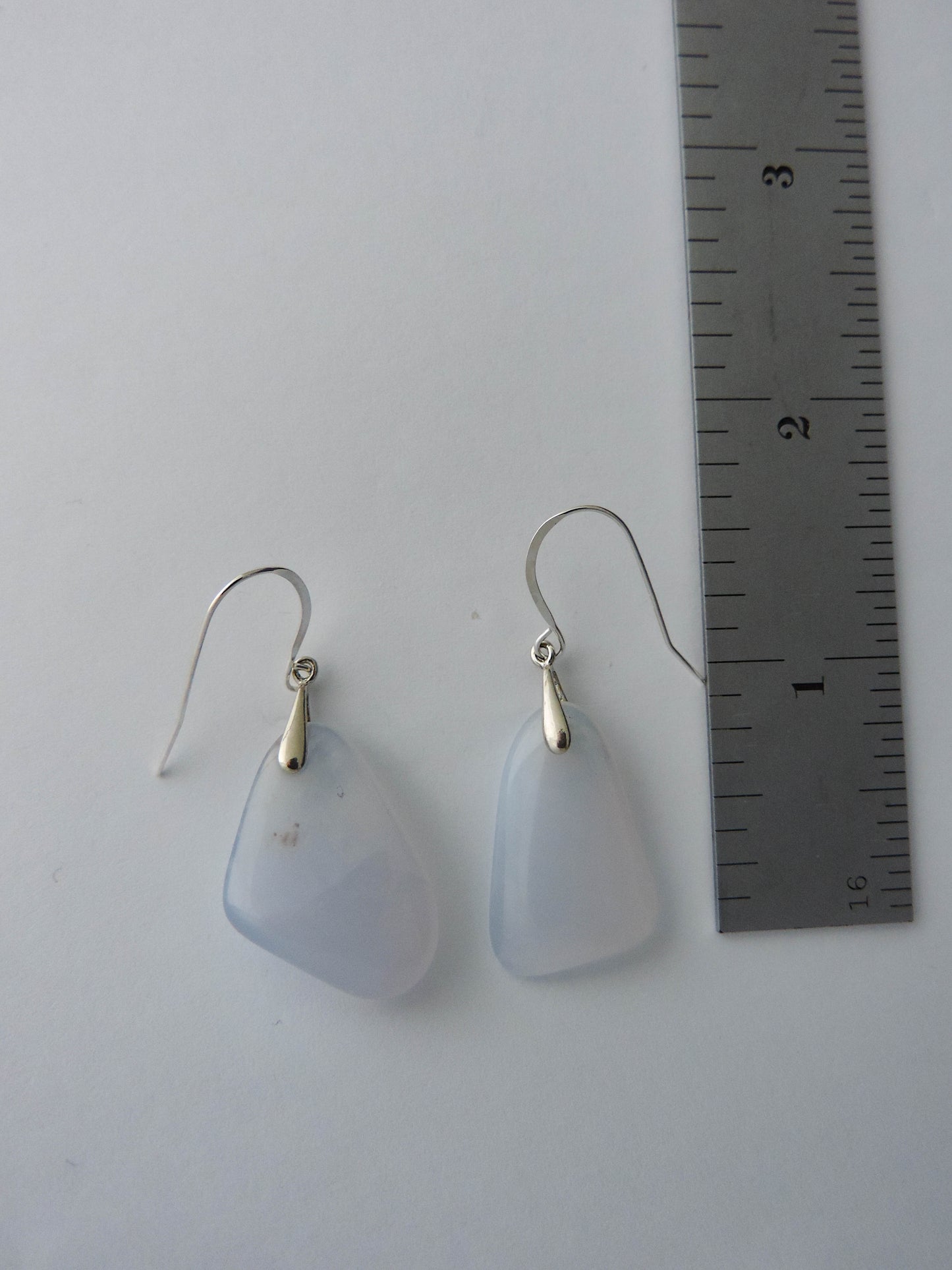 The bail and earring wires are authentic 925 sterling silver.  Wear these original earrings and stand out in a crowd!  Known as the Treasure State, Montana’s landscape is an abundant resource for precious and semi-precious stones.  One of the semi-precious stones, Madison Blue Agate, are featured in these earrings.