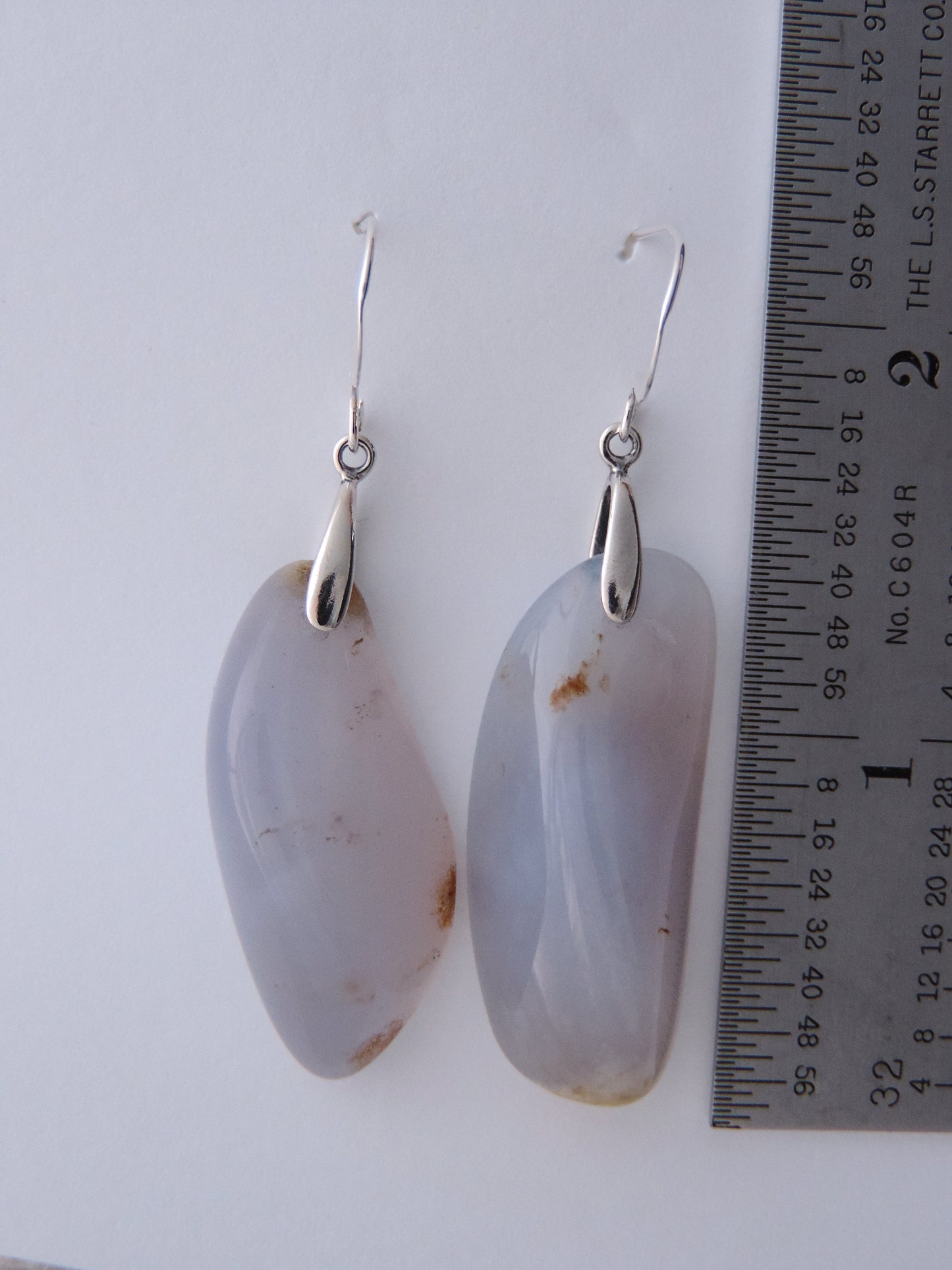 The bail and earring wires are authentic 925 sterling silver.  Wear these original earrings and stand out in a crowd!  Known as the Treasure State, Montana’s landscape is an abundant resource for precious and semi-precious stones.  One of the semi-precious stones, Madison Blue Agate, are featured in these earrings.