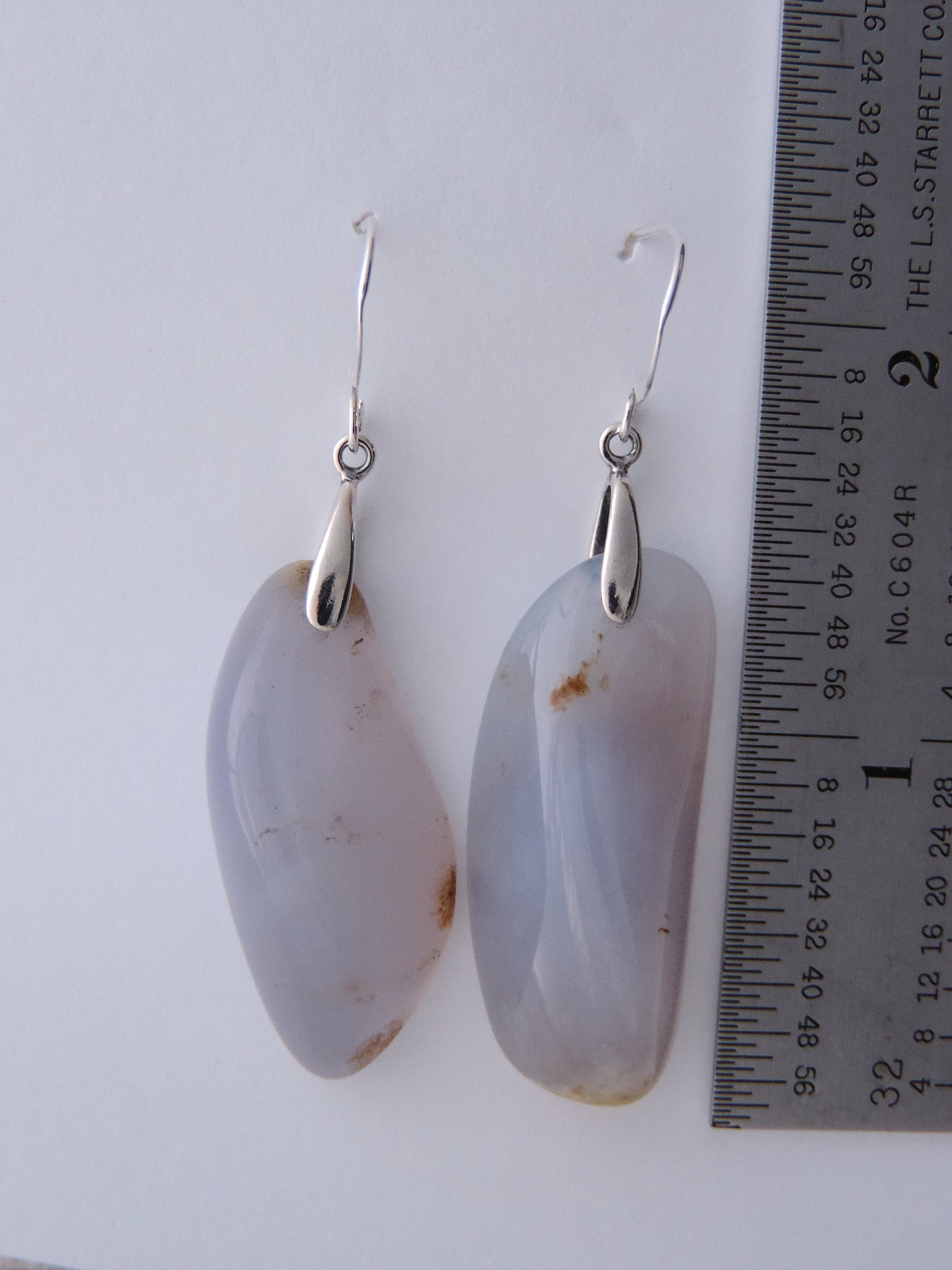 The bail and earring wires are authentic 925 sterling silver.  Wear these original earrings and stand out in a crowd!  Known as the Treasure State, Montana’s landscape is an abundant resource for precious and semi-precious stones.  One of the semi-precious stones, Madison Blue Agate, are featured in these earrings.