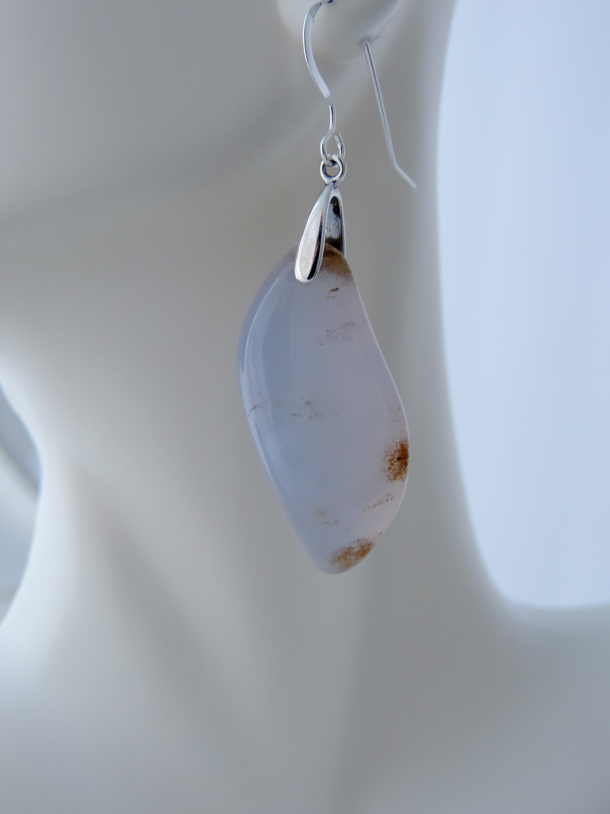 The bail and earring wires are authentic 925 sterling silver.  Wear these original earrings and stand out in a crowd!  Known as the Treasure State, Montana’s landscape is an abundant resource for precious and semi-precious stones.  One of the semi-precious stones, Madison Blue Agate, are featured in these earrings.