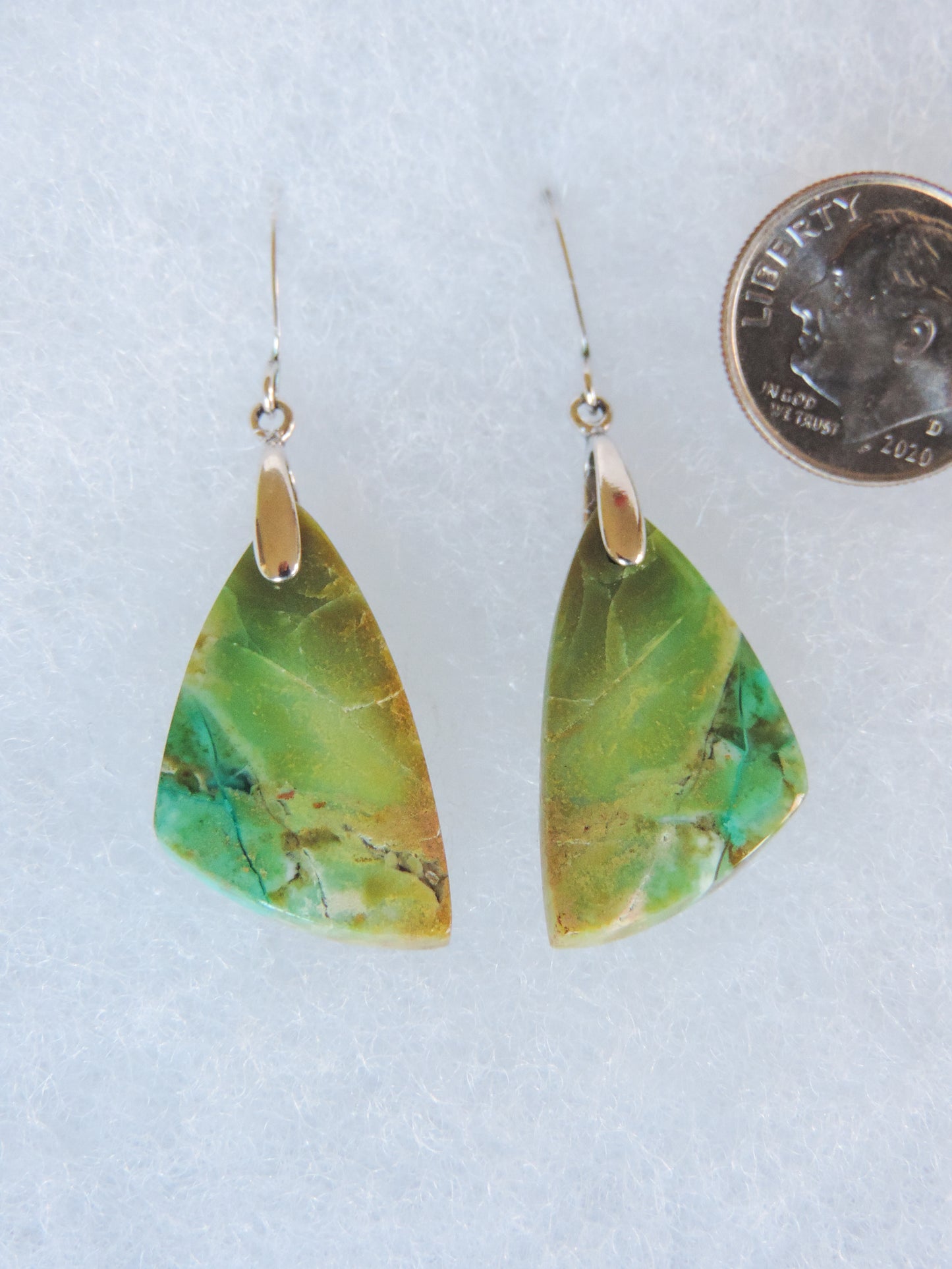 Over thousands of years, the woods’ organic material was replaced with opaline silica rich in copper, iron and manganese minerals.  These rich minerals are responsible for the amazing colors in the stone.  The bail and earring wires are authentic 925 sterling silver.