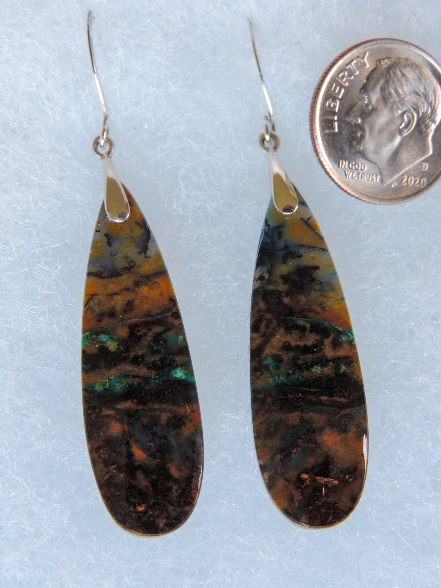 Extremely rare and lovely, Indonesian Blue Opalized Wood is a cherished material used by lapidary artists for creating stunning pieces of jewelry. The material was first found as pebbles and rounded stones in streams and near the slopes of three volcanoes in the West Java Province. The source deposit, an ancient petrified forest covered with pyroclastic flow from a volcanic eruption, was located in 2017 on the steep slopes of Mt. Tjakalak.