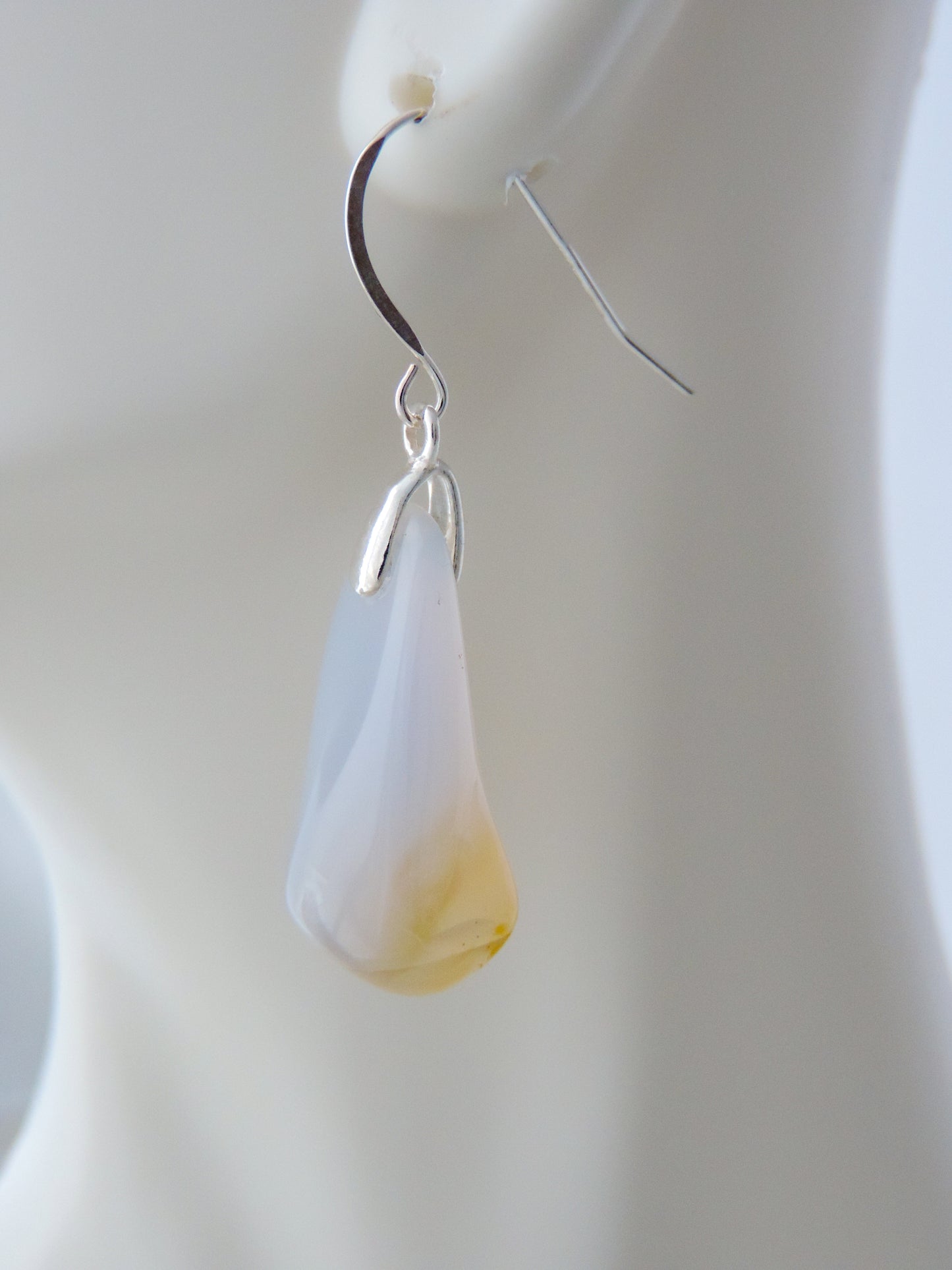 The bail and earring wires are authentic 925 sterling silver.  Wear these original earrings and stand out in a crowd!  Known as the Treasure State, Montana’s landscape is an abundant resource for precious and semi-precious stones.  One of the semi-precious stones, Madison Blue Agate, are featured in these earrings.