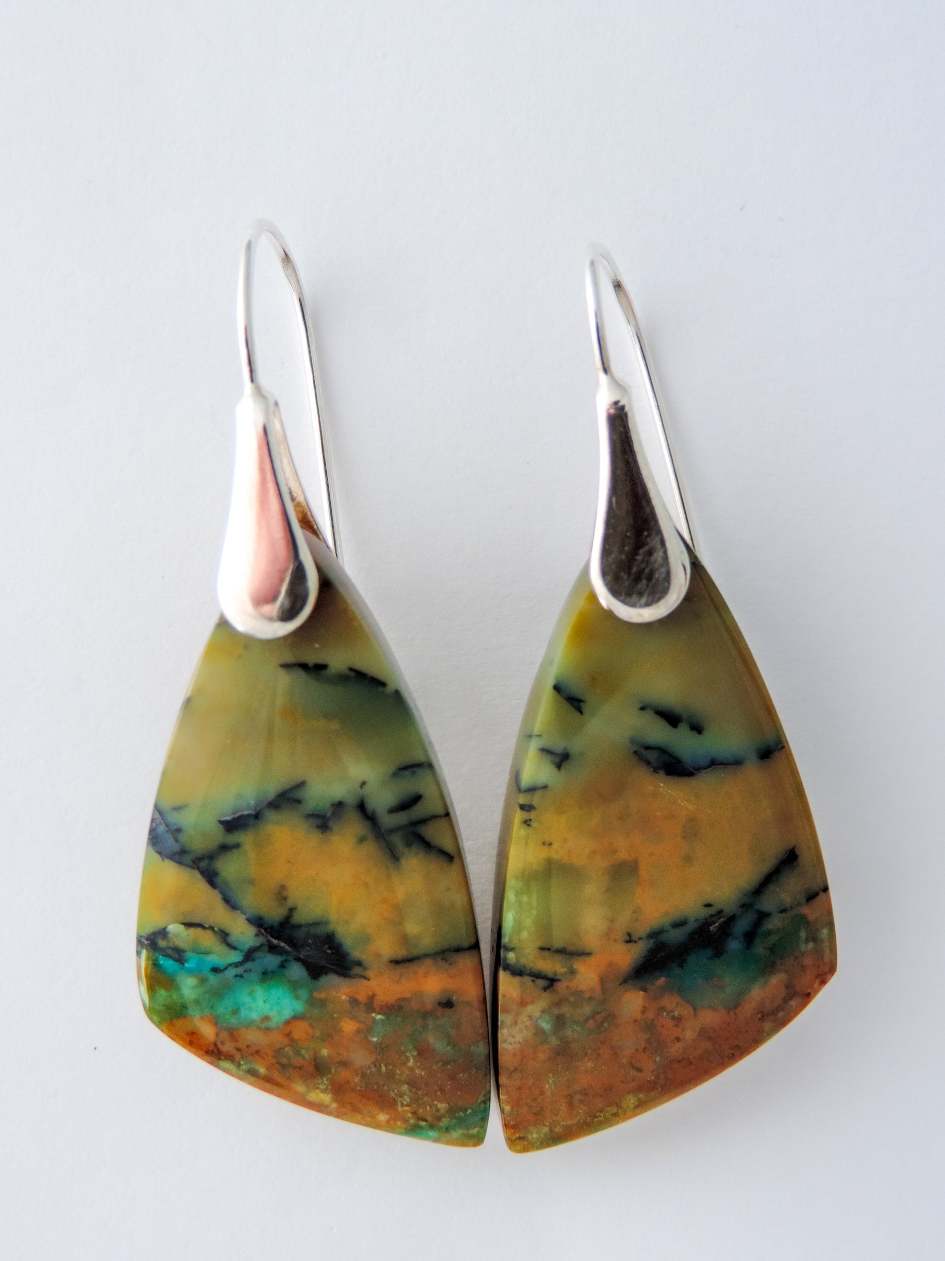 The bail and earring wires are authentic 925 sterling silver.  Feel treasured when you wear these earrings! Extremely rare and lovely, Indonesian Blue Opalized Wood is a cherished material used by lapidary artists for creating stunning pieces of jewelry.  The material was first found as pebbles and rounded stones in streams and near the slopes of three volcanoes in the West Java Province.