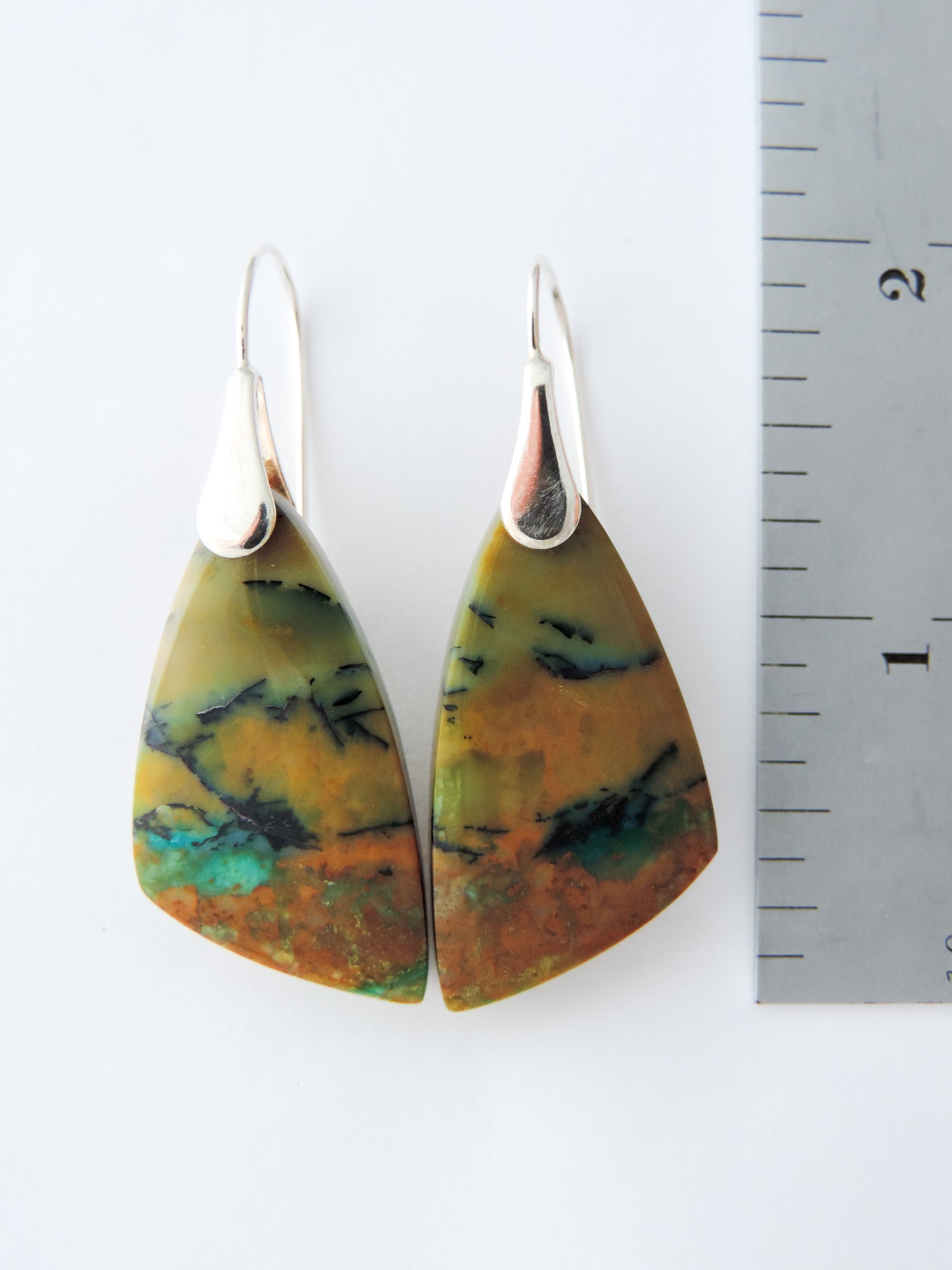 The bail and earring wires are authentic 925 sterling silver.  Feel treasured when you wear these earrings! Extremely rare and lovely, Indonesian Blue Opalized Wood is a cherished material used by lapidary artists for creating stunning pieces of jewelry.  The material was first found as pebbles and rounded stones in streams and near the slopes of three volcanoes in the West Java Province.