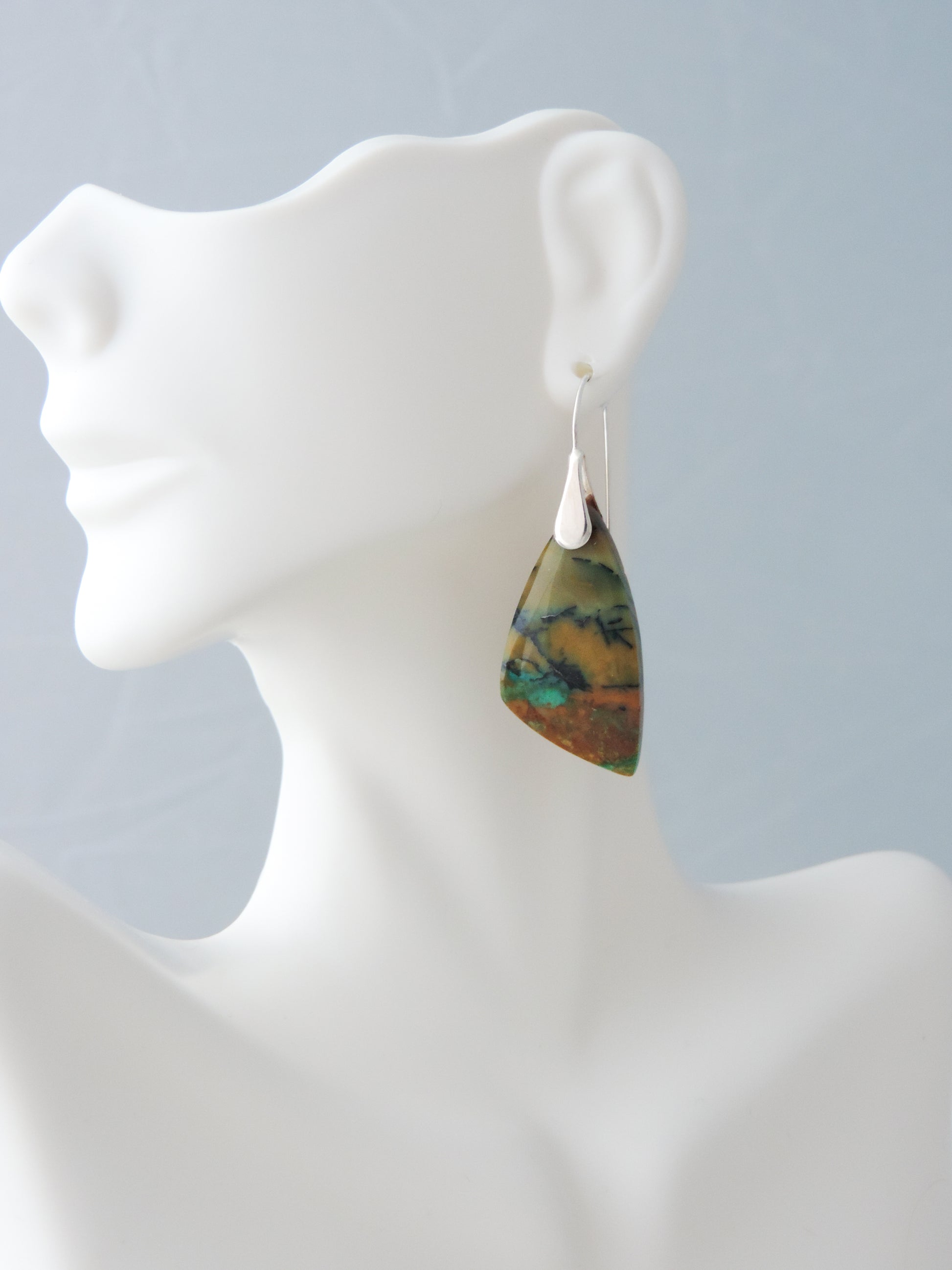 The bail and earring wires are authentic 925 sterling silver.  Feel treasured when you wear these earrings! Extremely rare and lovely, Indonesian Blue Opalized Wood is a cherished material used by lapidary artists for creating stunning pieces of jewelry.  The material was first found as pebbles and rounded stones in streams and near the slopes of three volcanoes in the West Java Province.