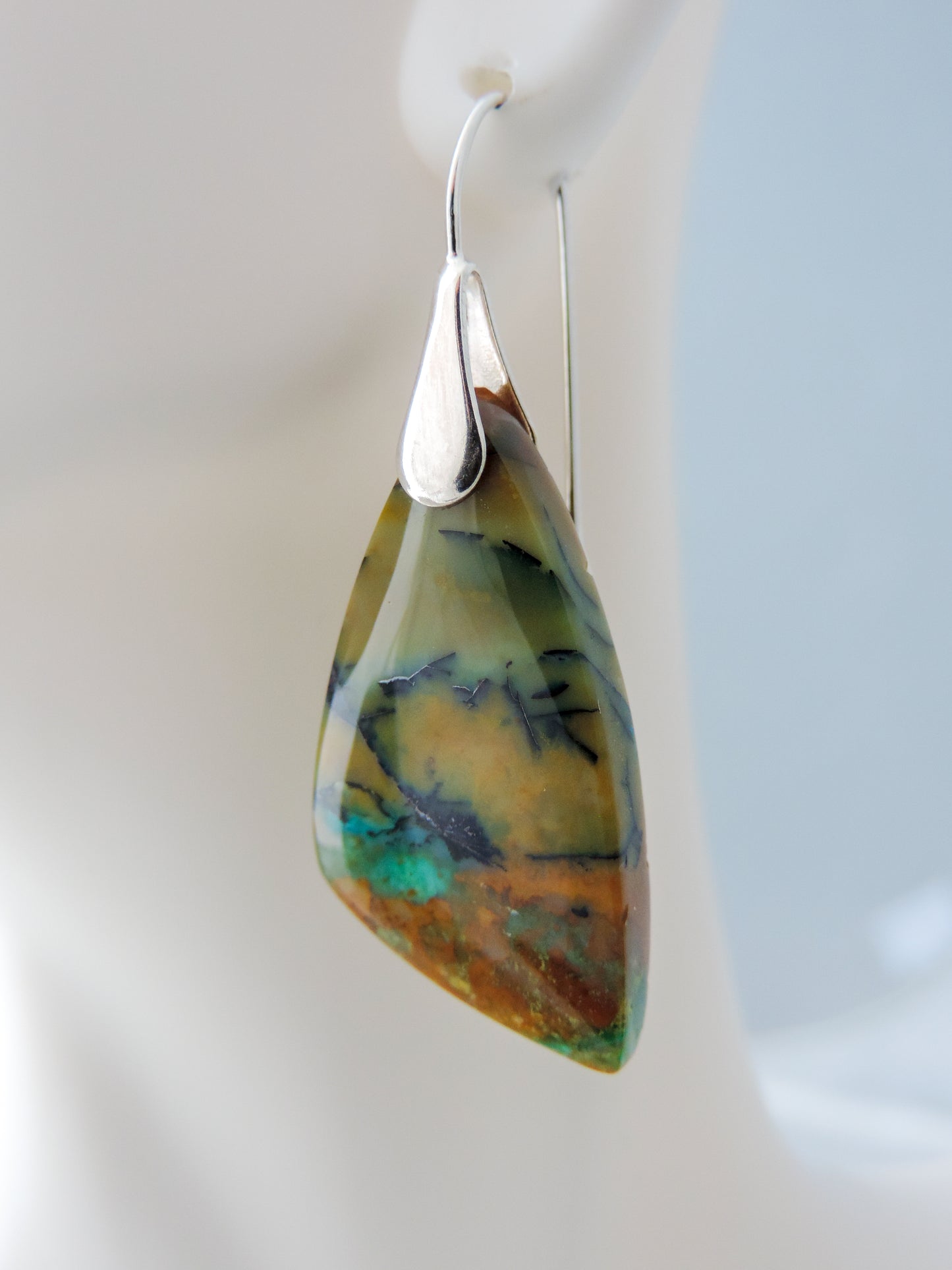 The bail and earring wires are authentic 925 sterling silver.  Feel treasured when you wear these earrings! Extremely rare and lovely, Indonesian Blue Opalized Wood is a cherished material used by lapidary artists for creating stunning pieces of jewelry.  The material was first found as pebbles and rounded stones in streams and near the slopes of three volcanoes in the West Java Province.