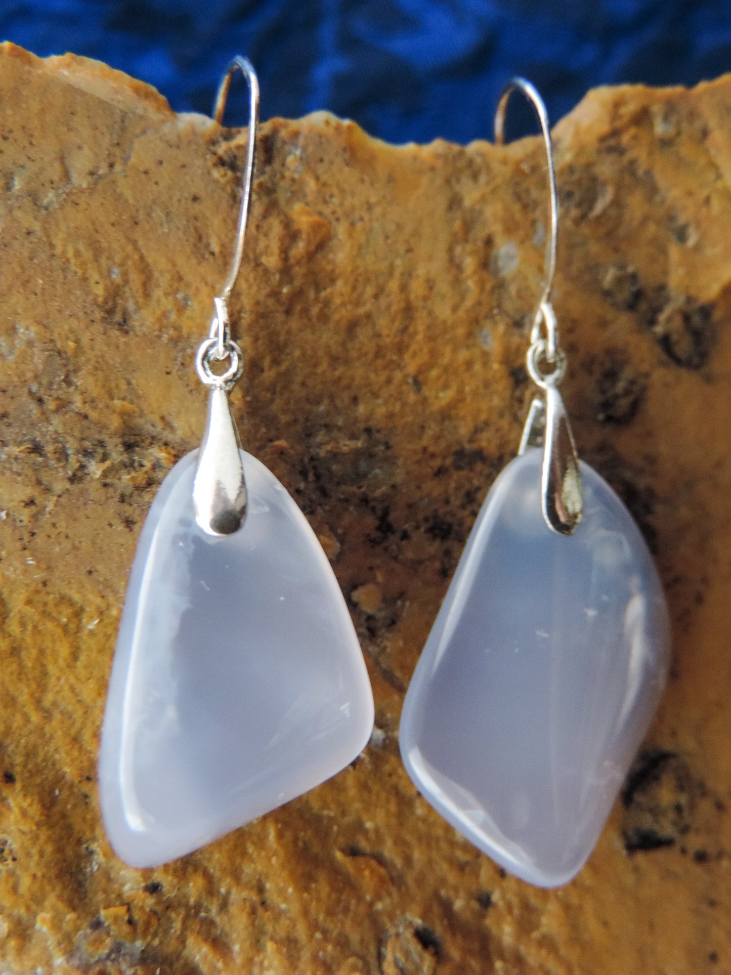 The bail and earring wires are authentic 925 sterling silver.  Wear these original earrings and stand out in a crowd!  Known as the Treasure State, Montana’s landscape is an abundant resource for precious and semi-precious stones.  One of the semi-precious stones, Madison Blue Agate, are featured in these earrings.